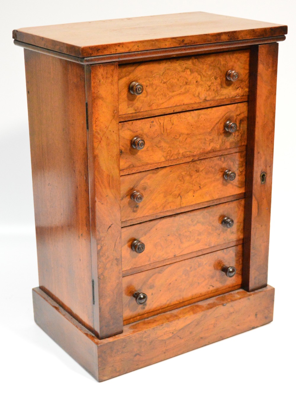 A Victorian walnut miniature Wellington chest, the rectangular top above five drawers with twin side