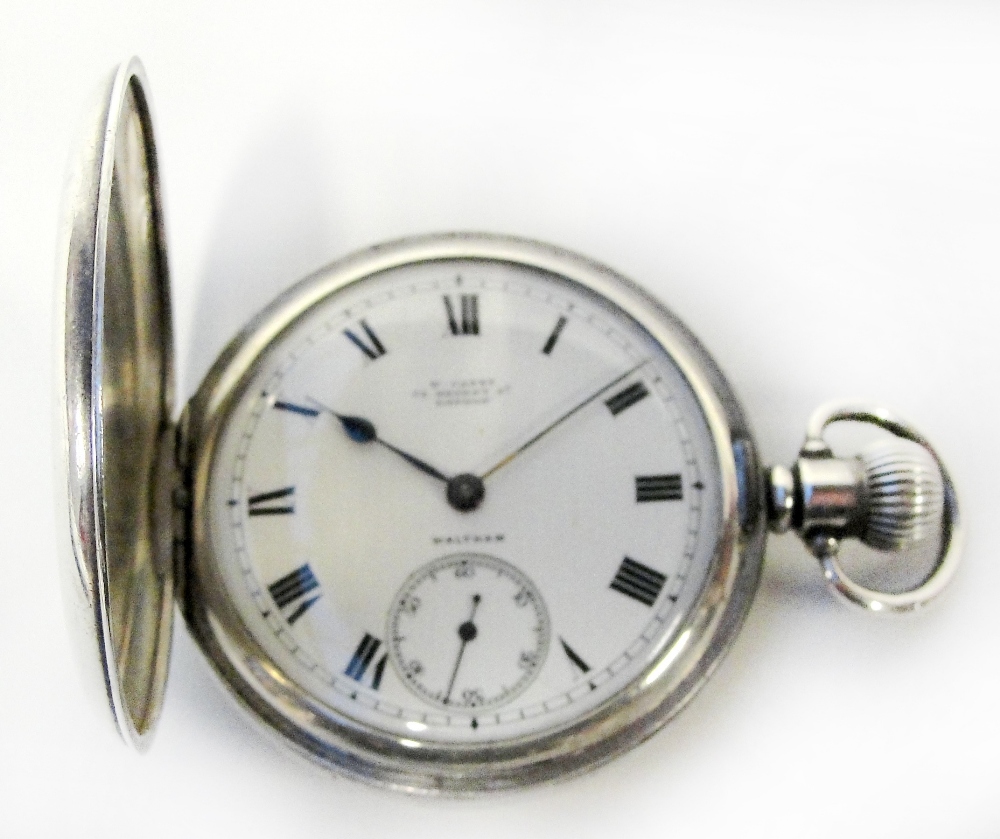 An early 20th century silver half hunter cased Waltham pocket watch, the circular white enamel