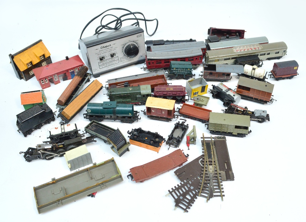 A box of Dublo trains, carriages, track and accessories.