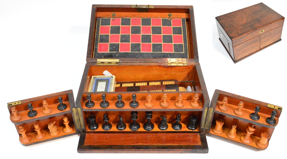 A 19th century rosewood travelling games compendium, the hinged lid revealing a folding playing