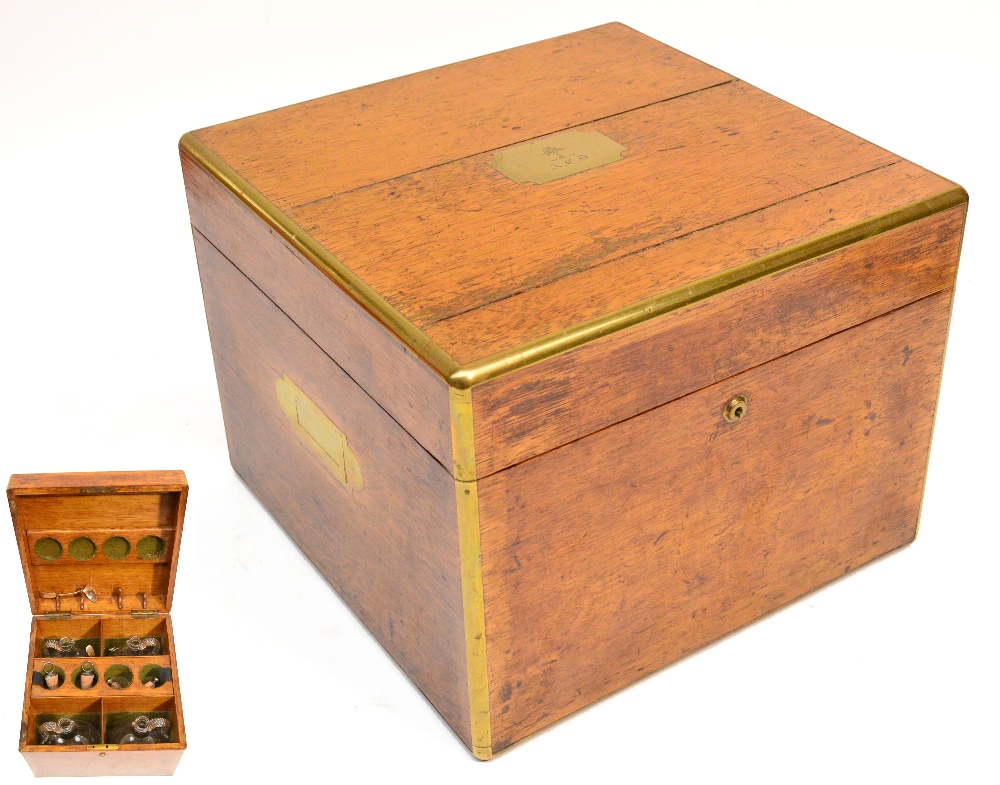 A good 19th century oak and brass bound travelling decanter set, the hinged lid centred with a