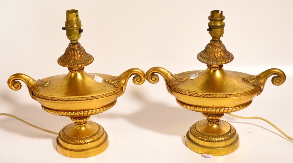 A pair of decorative gilt metal urn shaped table lamps, height 28cm.