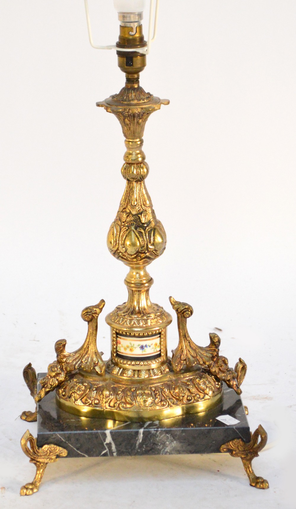 An ornate gilt metal lamp.