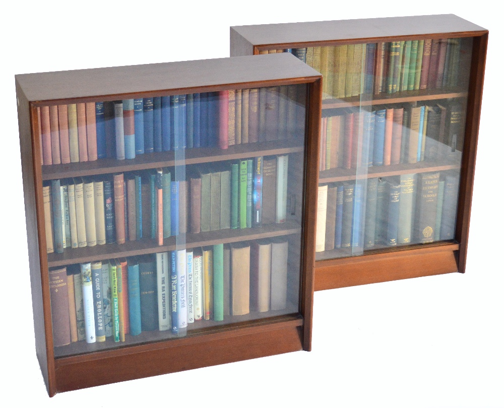 A pair of bookcases with sliding glazed doors, and their contents of assorted novels, classics,