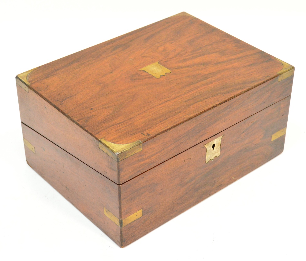 A Victorian walnut and brass bound rectangular writing slope the hinged lid enclosing leather