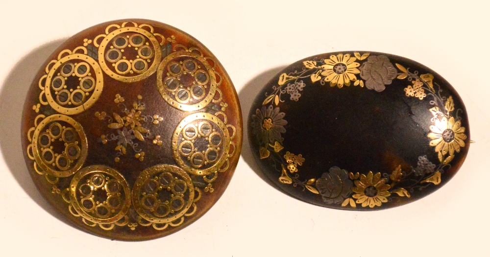 A late Victorian tortoiseshell pique inlaid oval brooch decorated with floral sprays, and a