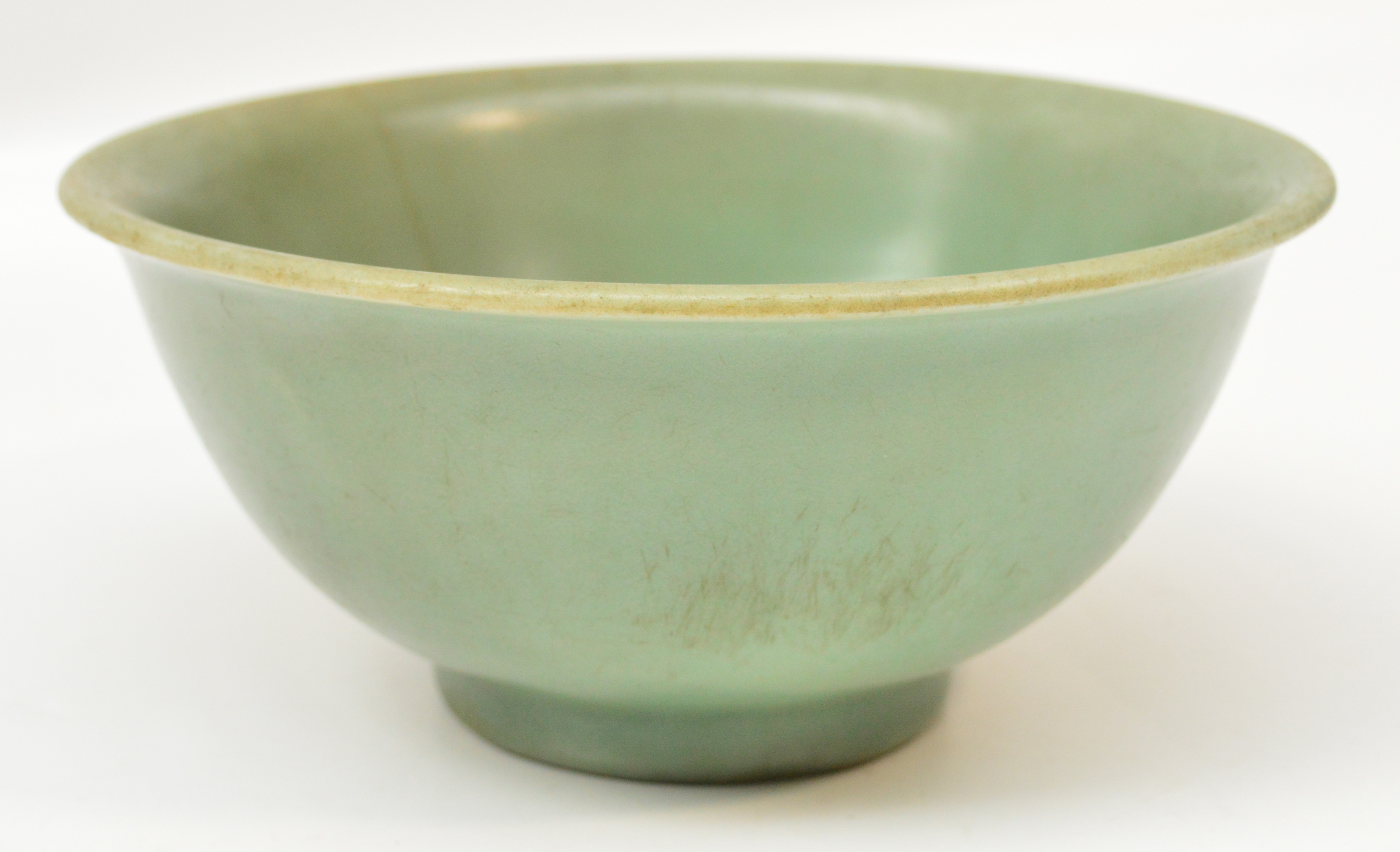 A 13th century Chinese bowl of ogee form with thick celadon glaze throughout, diameter 19cm,