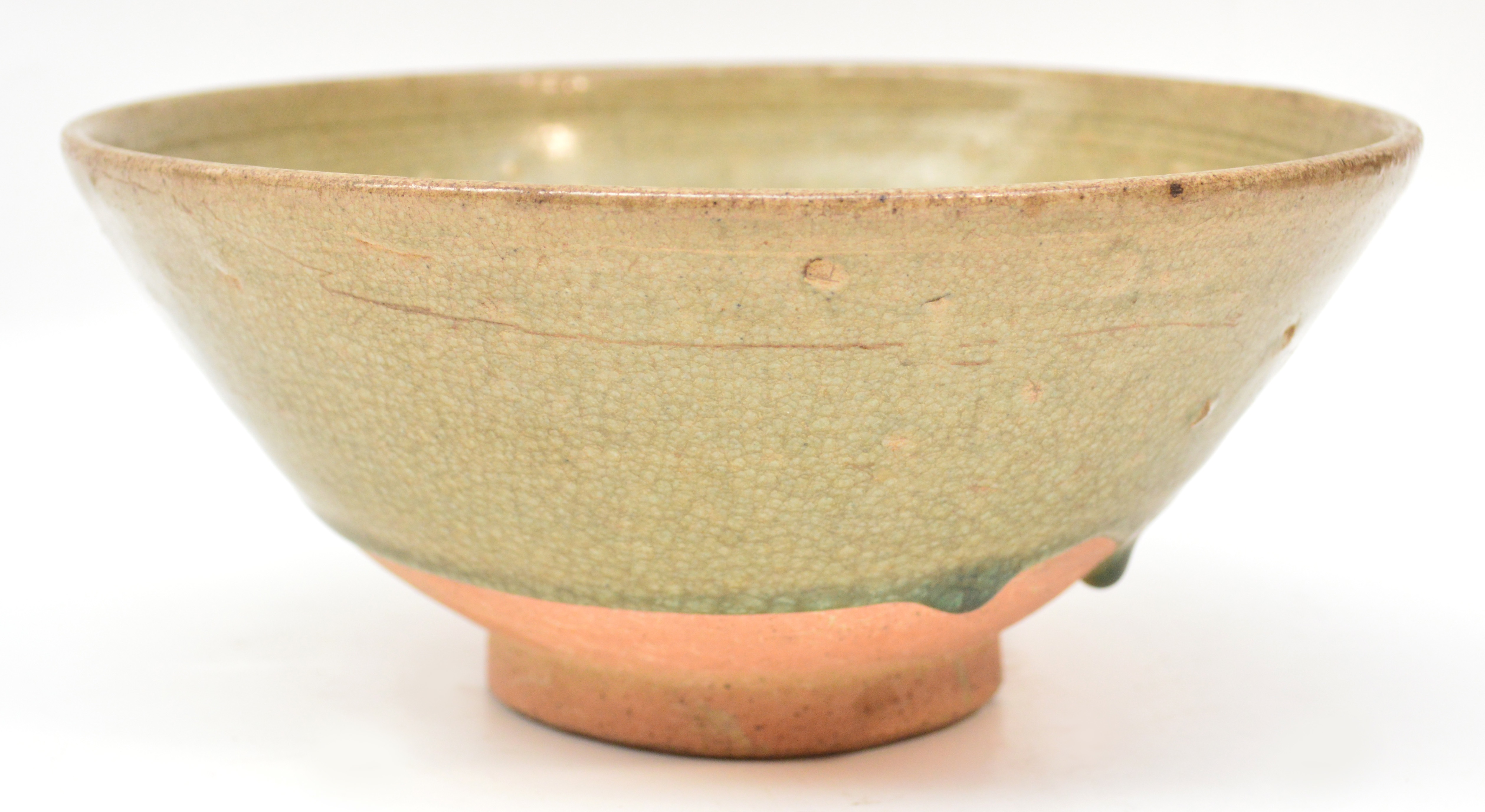 A 15th century Sawankhalok celadon glazed bowl incised with vertical lines to the interior, and