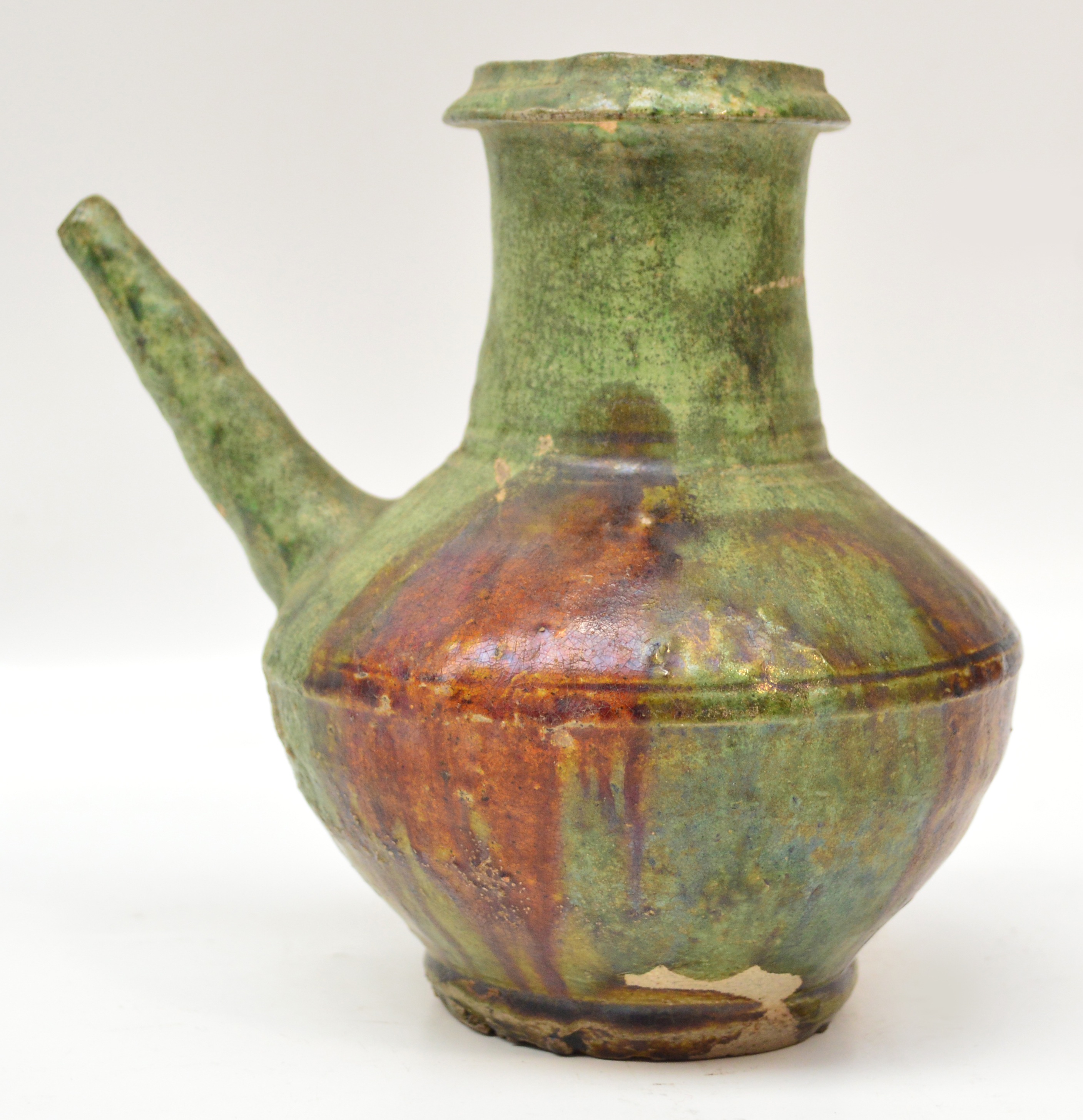 A 14th century Chinese lead glazed Kendi splashed with amber glaze over a green ground, Quanzhou