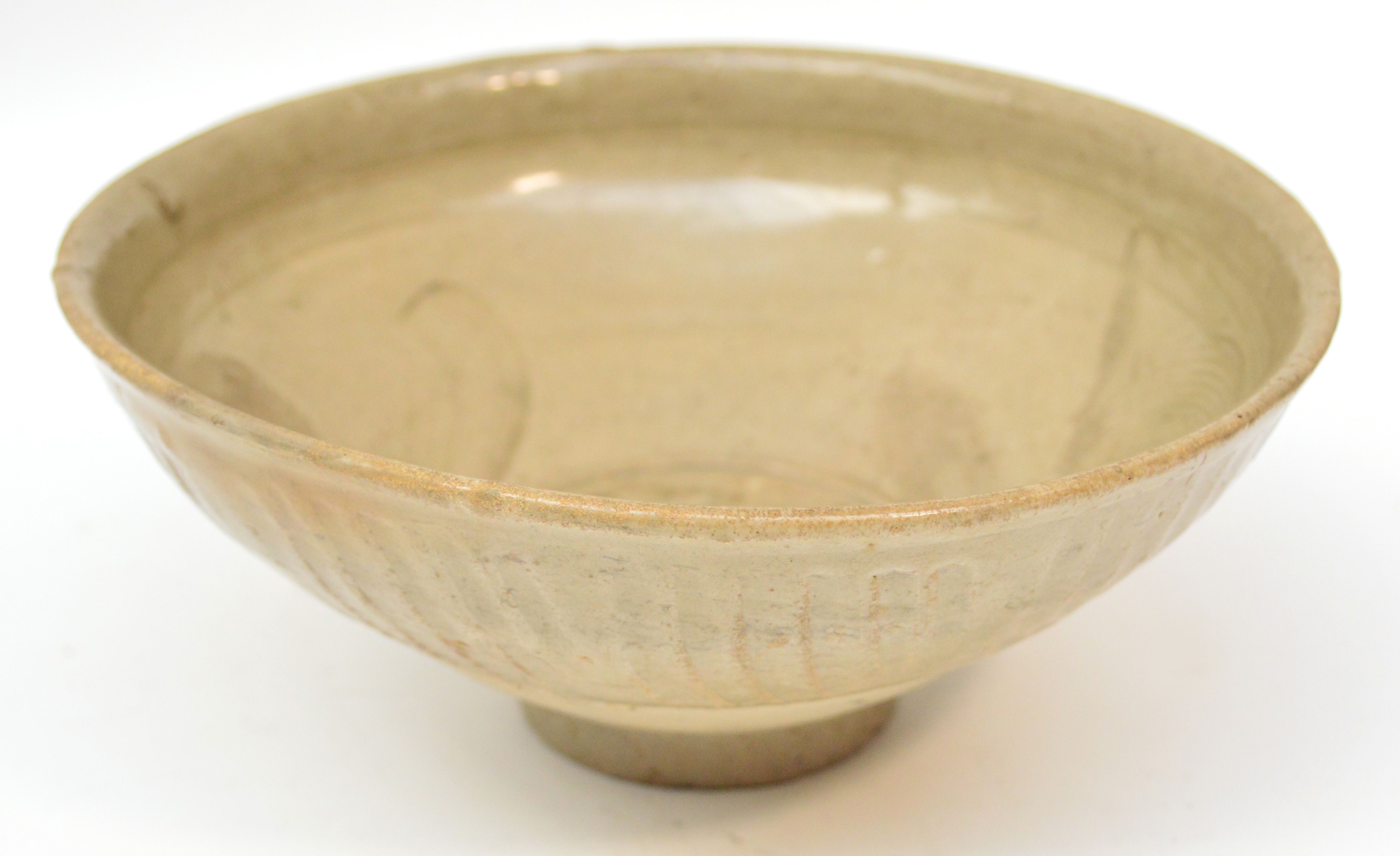 An 11th century Chinese grey stoneware celadon glazed bowl with incised and combed decoration to the