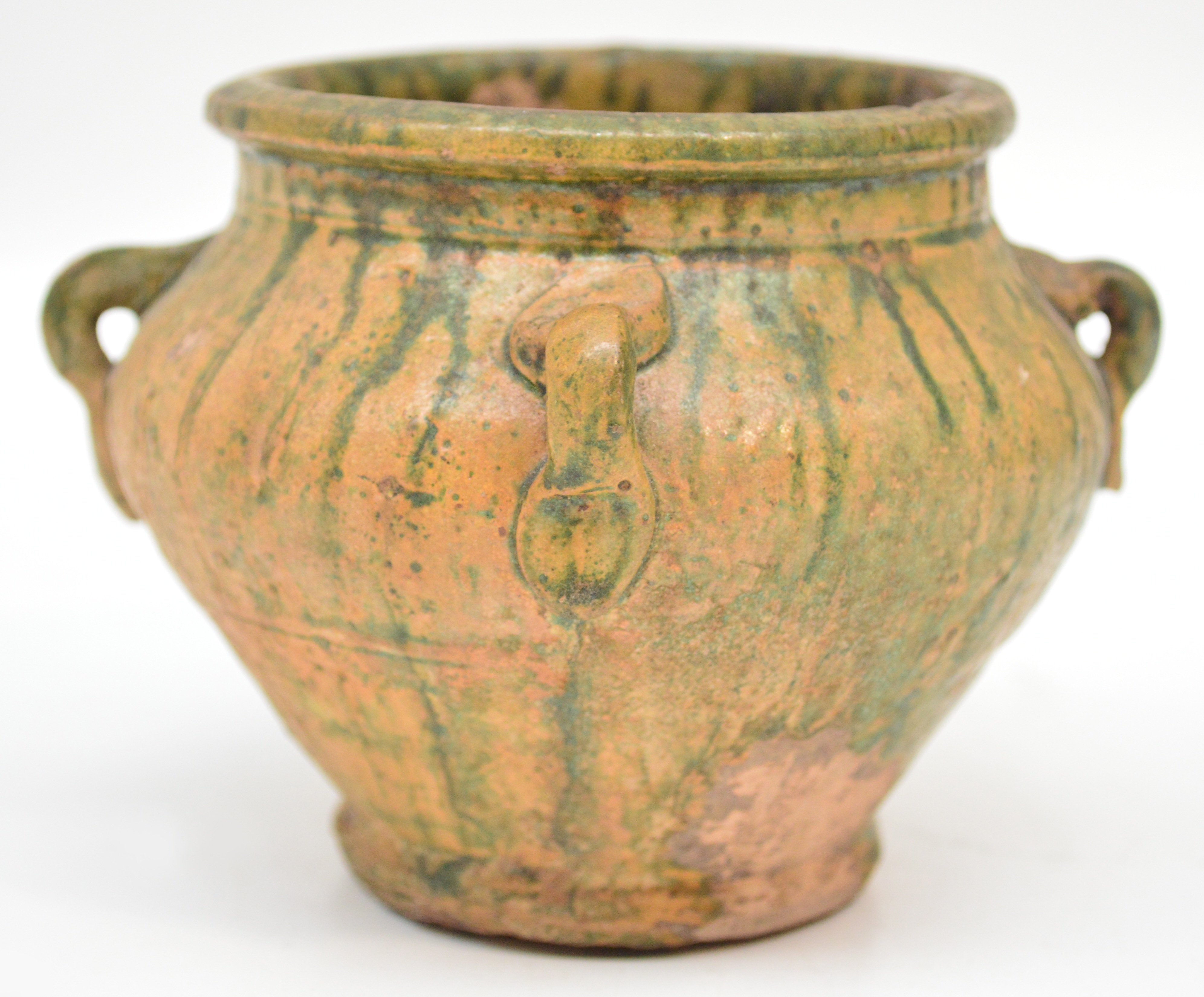 An unusual 14th century Chinese vase with four lug handles and green splash glaze over amber