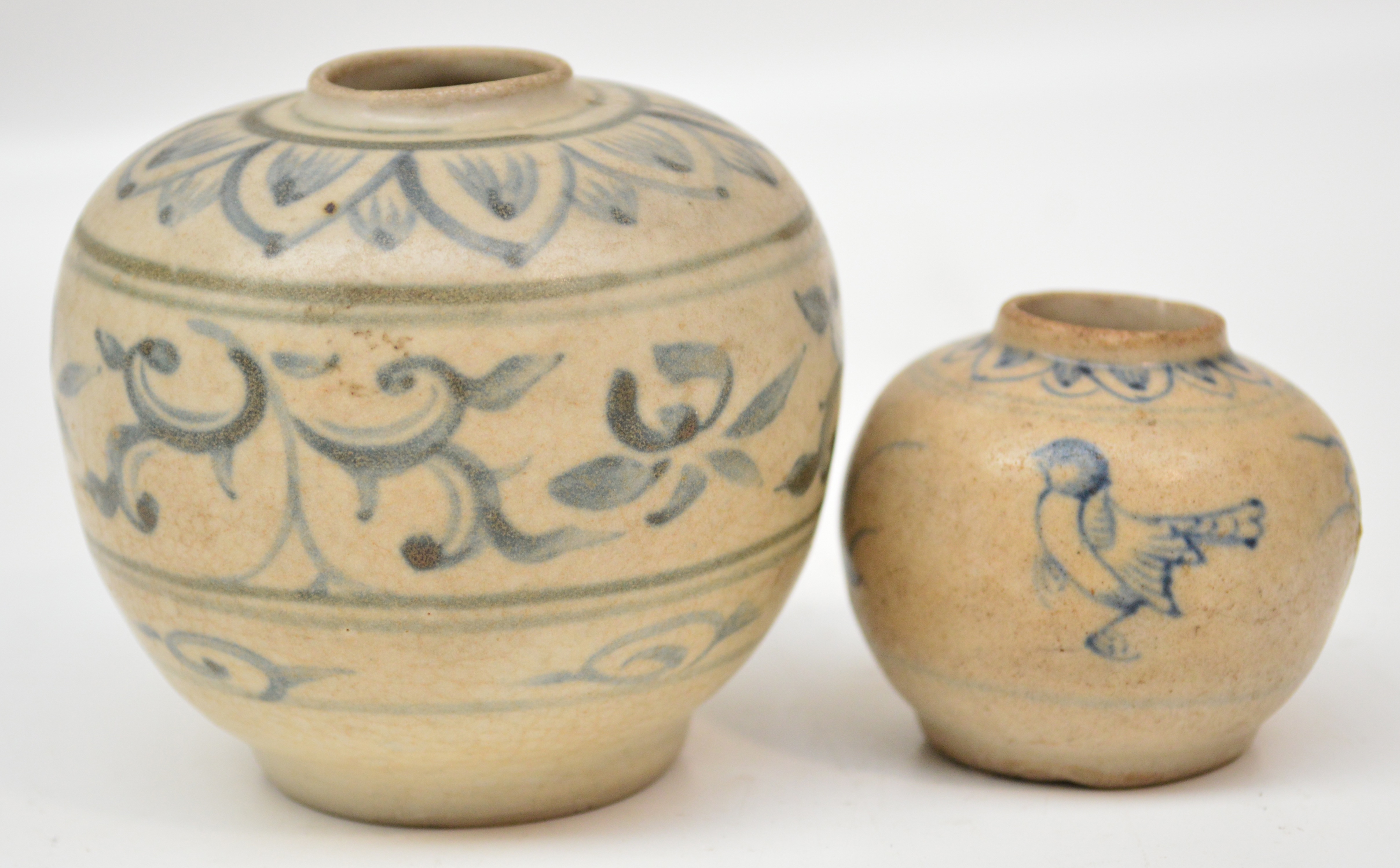 Two 15th century Annamese pottery jars, both painted in underglaze blue, one with birds and floral