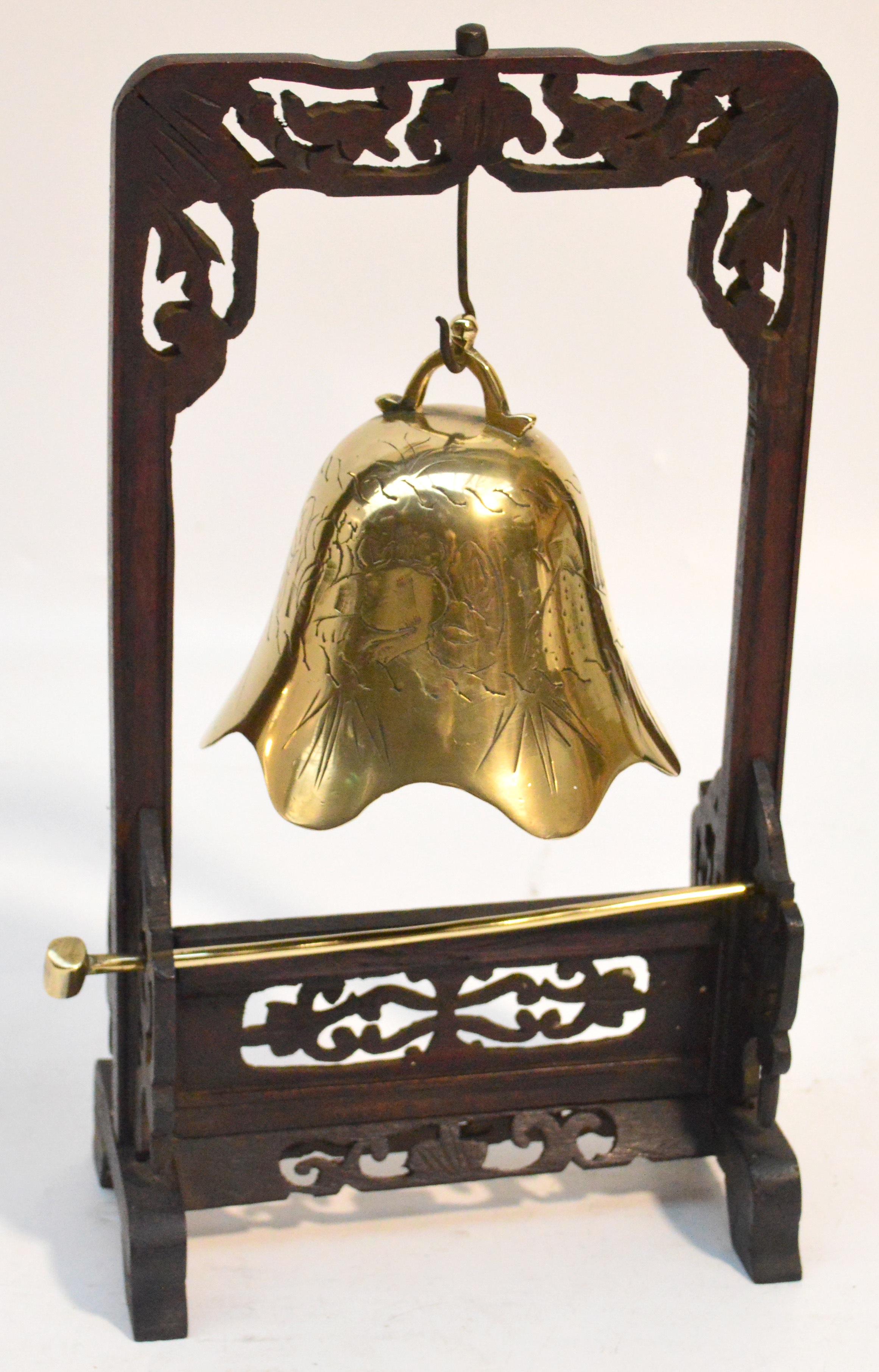 A 20th century Chinese brass gong in pierced wooden frame, height 31cm.
