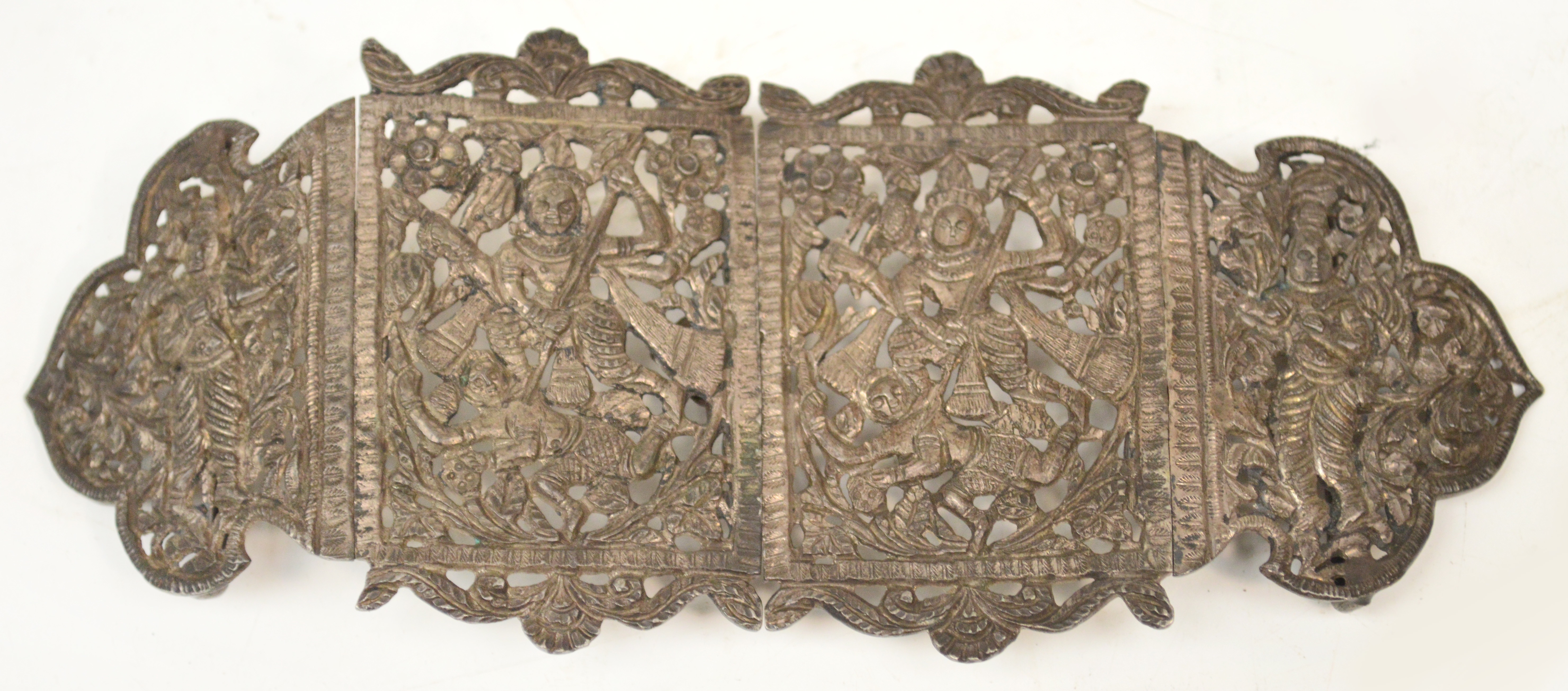 An early 20th century Indian white metal buckle of four sections and pierced and engraved with