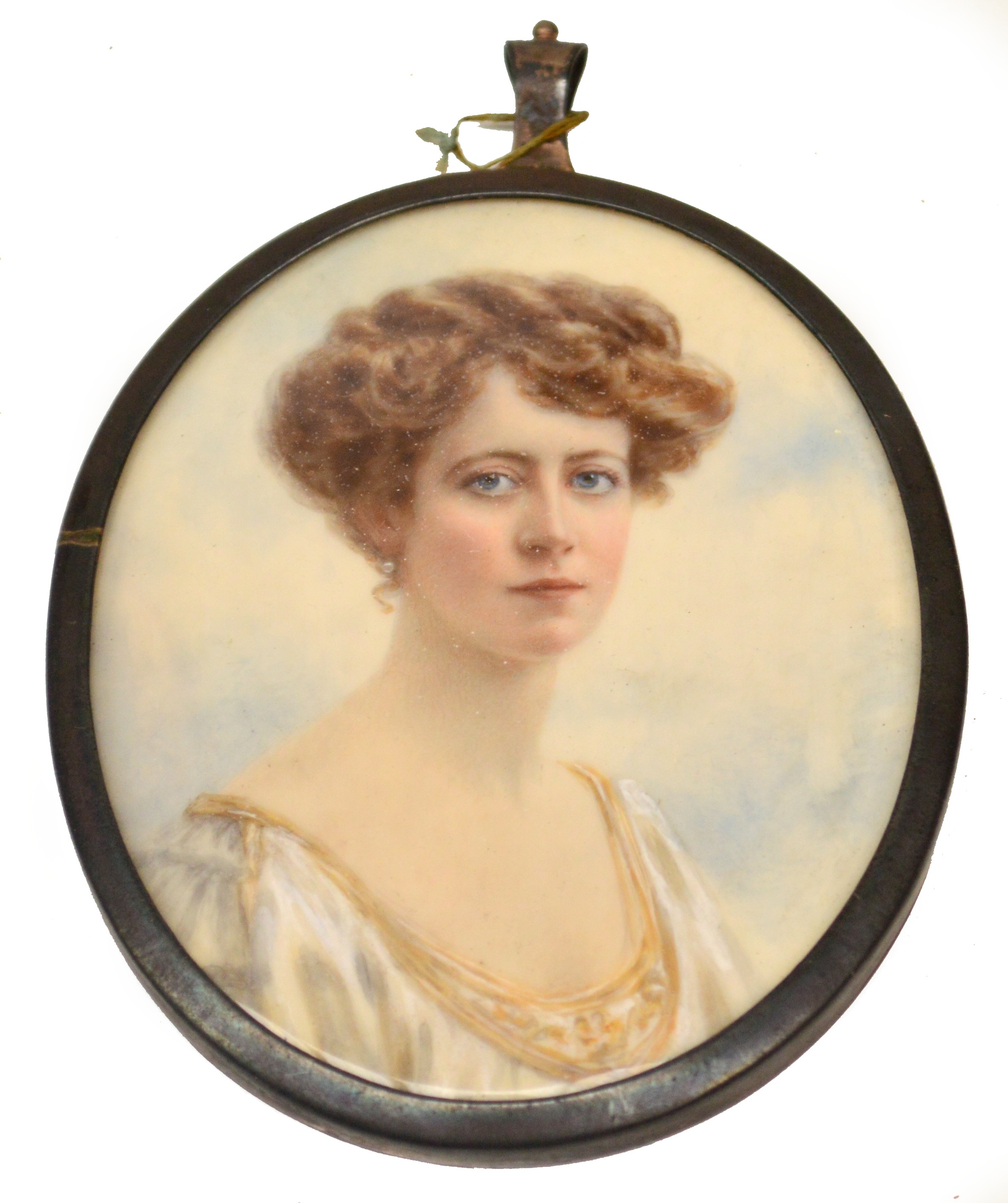 An Edwardian oval portrait miniature depicting a young woman wearing white dress, unsigned, 7.5 x