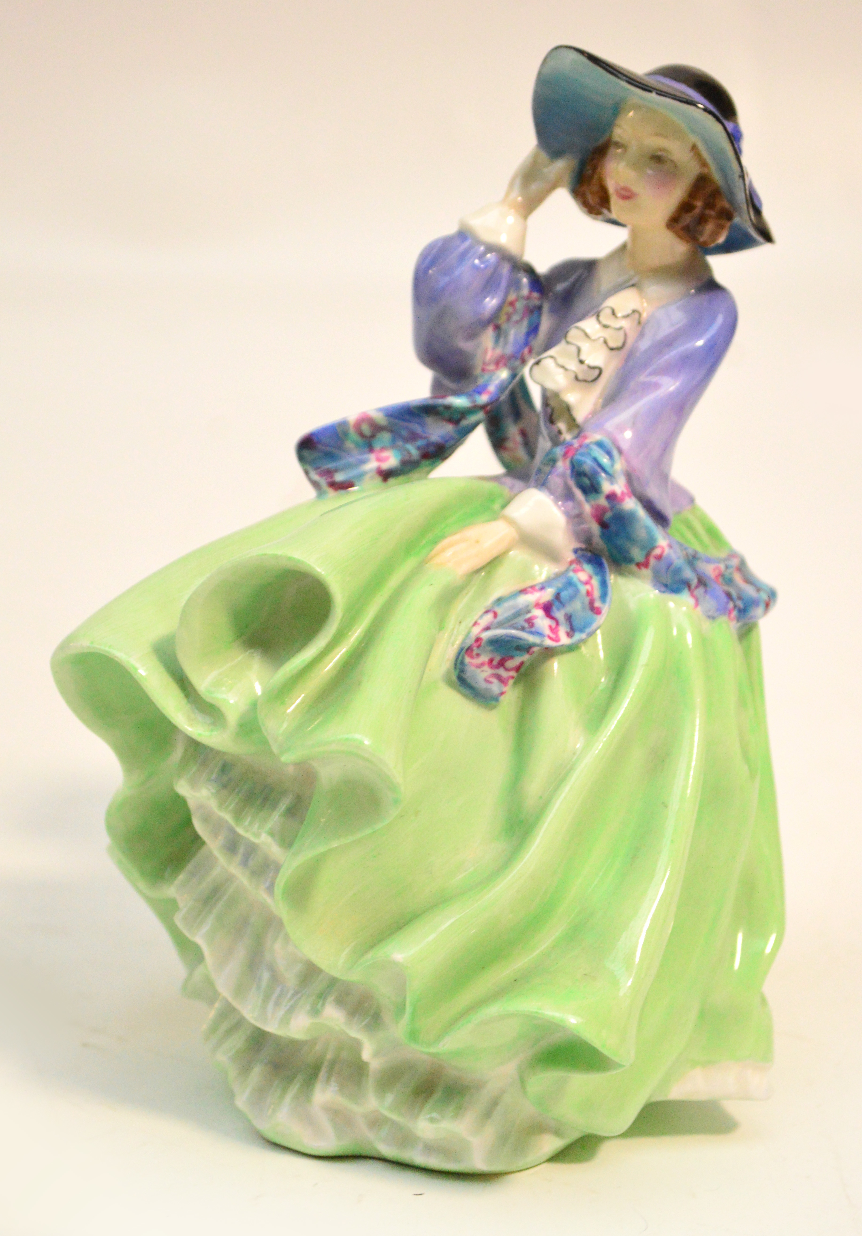 A Royal Doulton figurine HN1833 "Top O' The Hill" (green dress). CONDITION REPORT: Appears good with