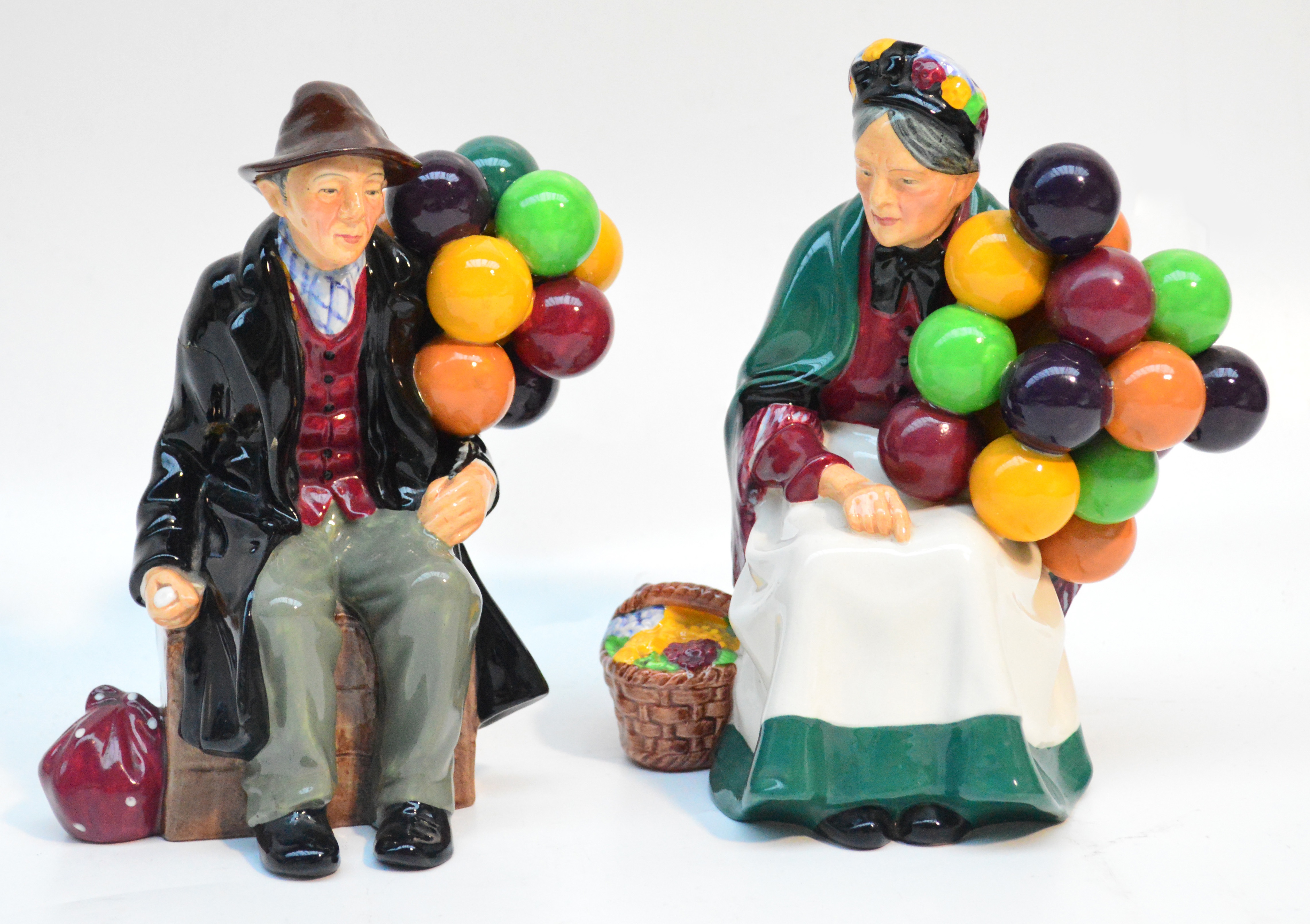 Two Royal Doulton figurines HN1315 "The Old Balloon Seller" and HN1954 "The Balloon Man" (af).