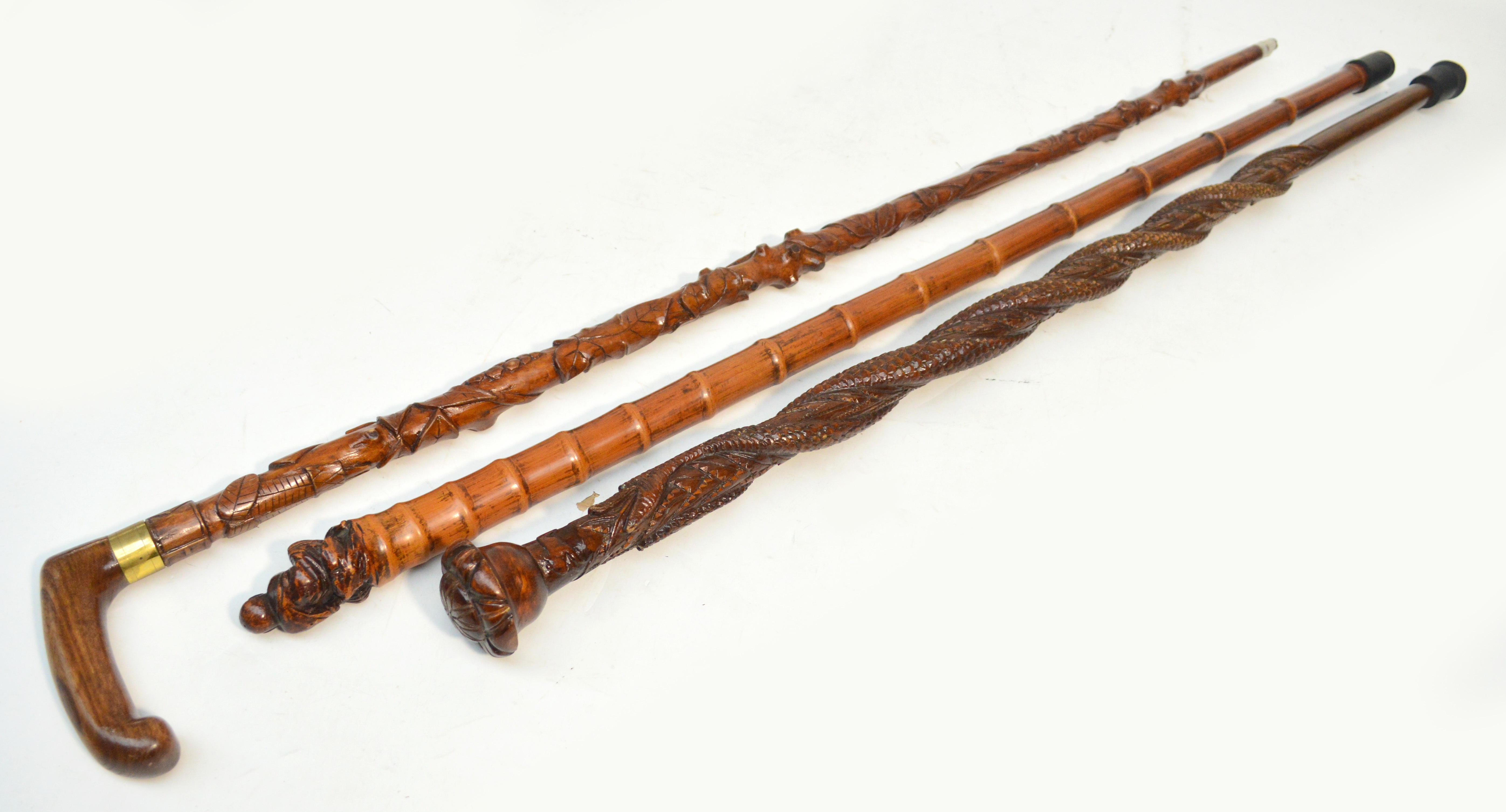 A Chinese carved bamboo walking cane, length 92cm, a carved walking cane decorated with two snakes