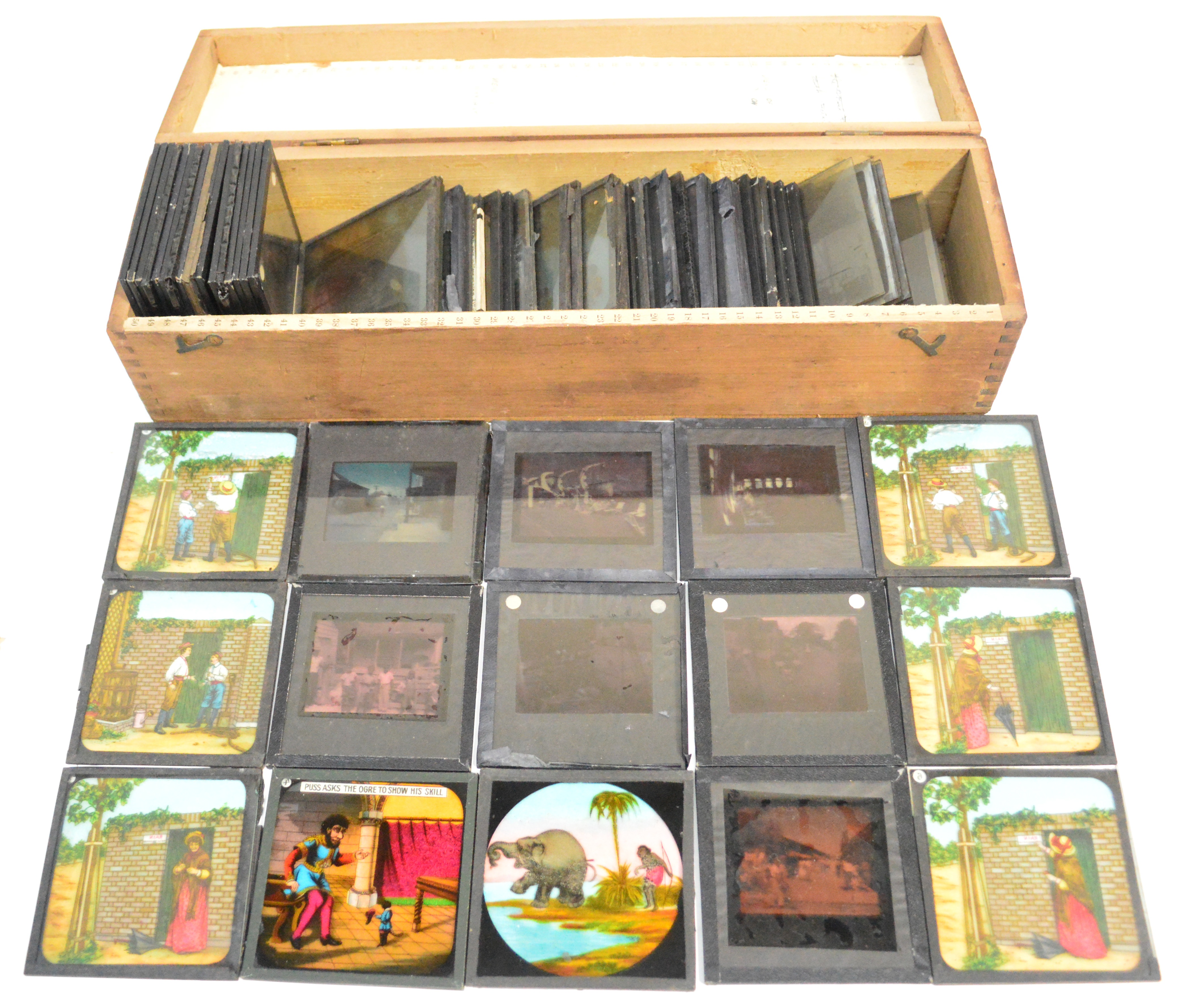 A collection of vintage magic lantern slides, some coloured, some black and white.
