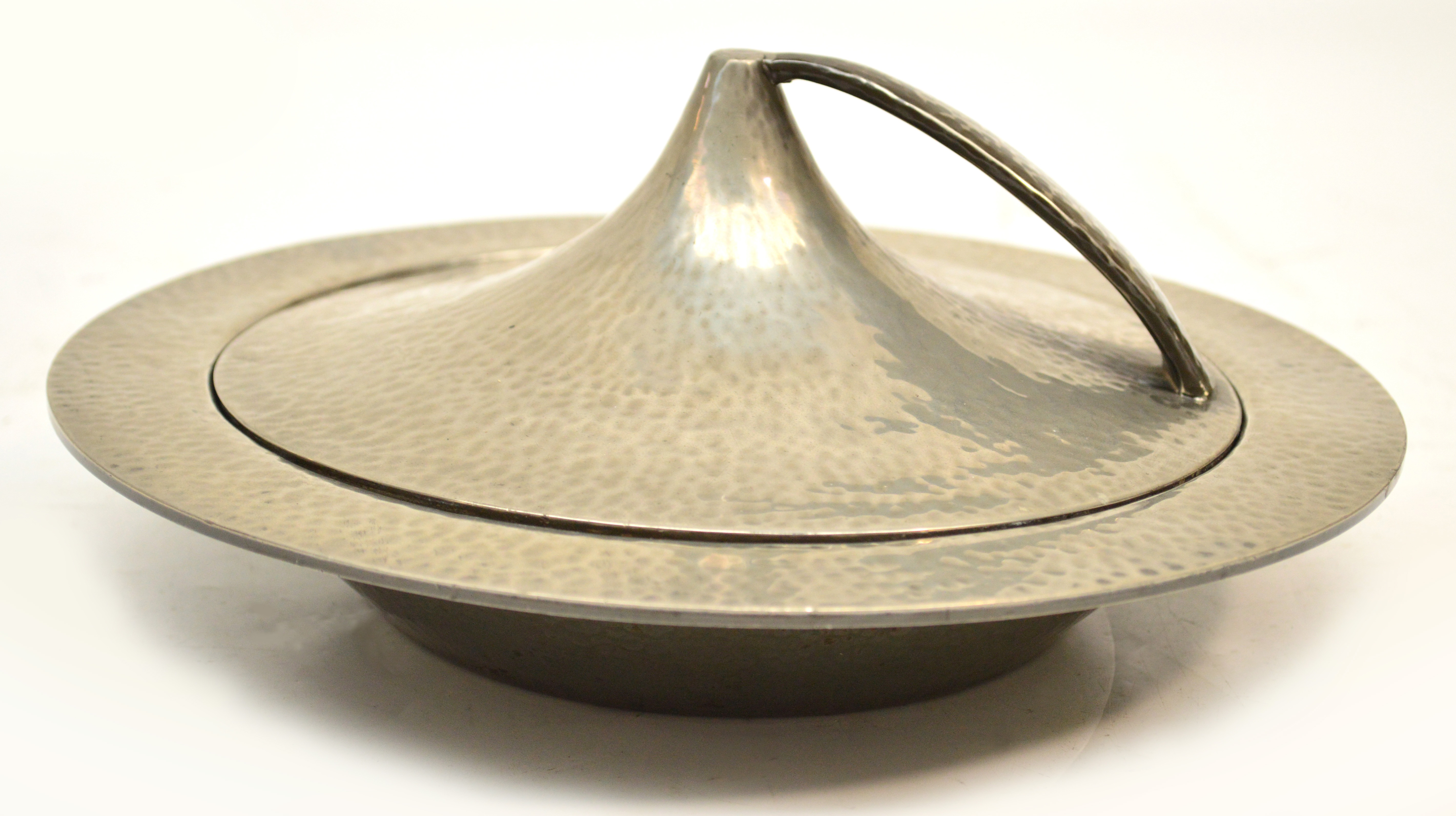 A Liberty & Co "Tudric" circular beaten pewter muffin dish and cover designed by Archibald Knox with