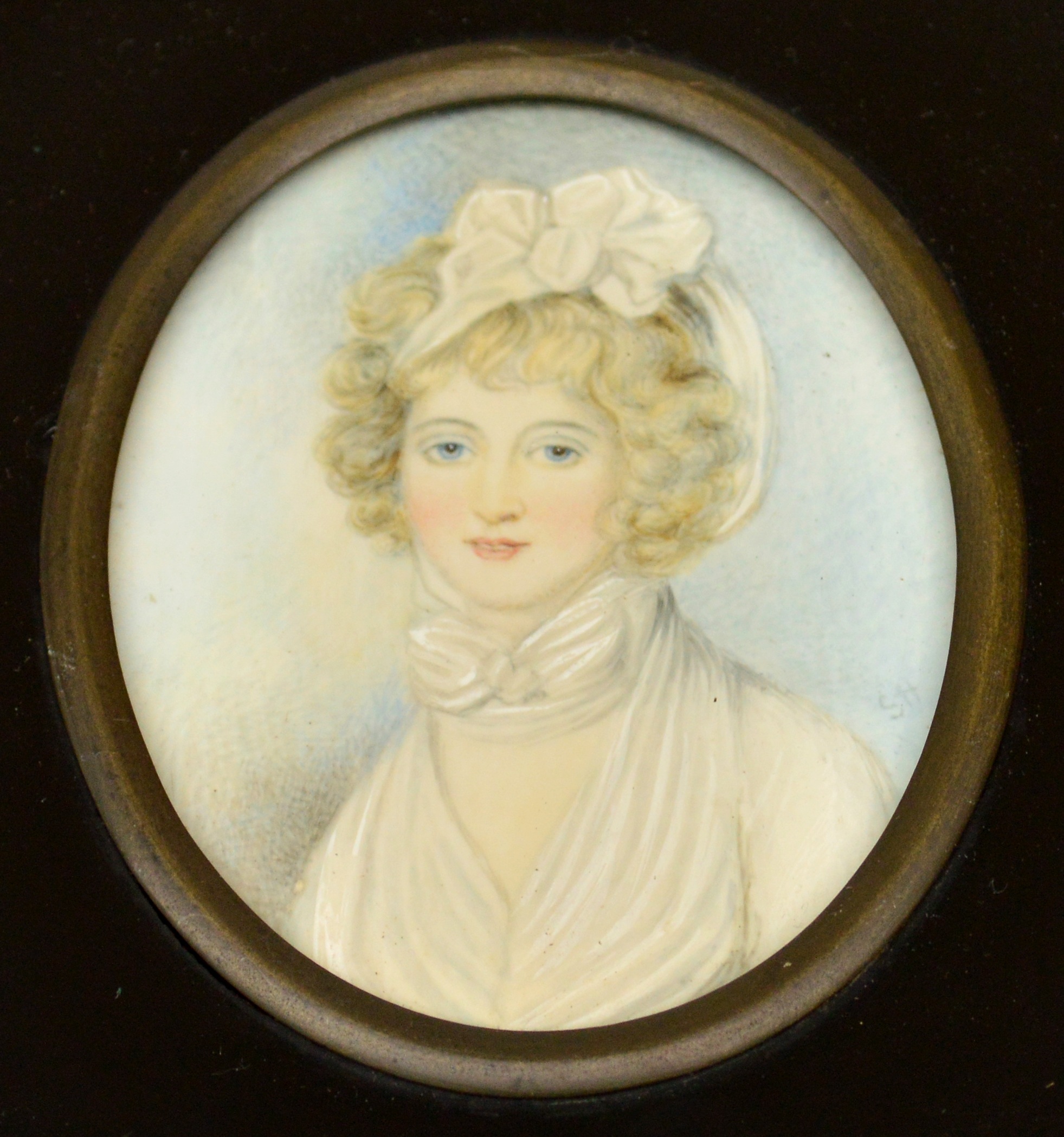 Late 19th century English school; oval portrait miniature depicting a young woman with bow in her