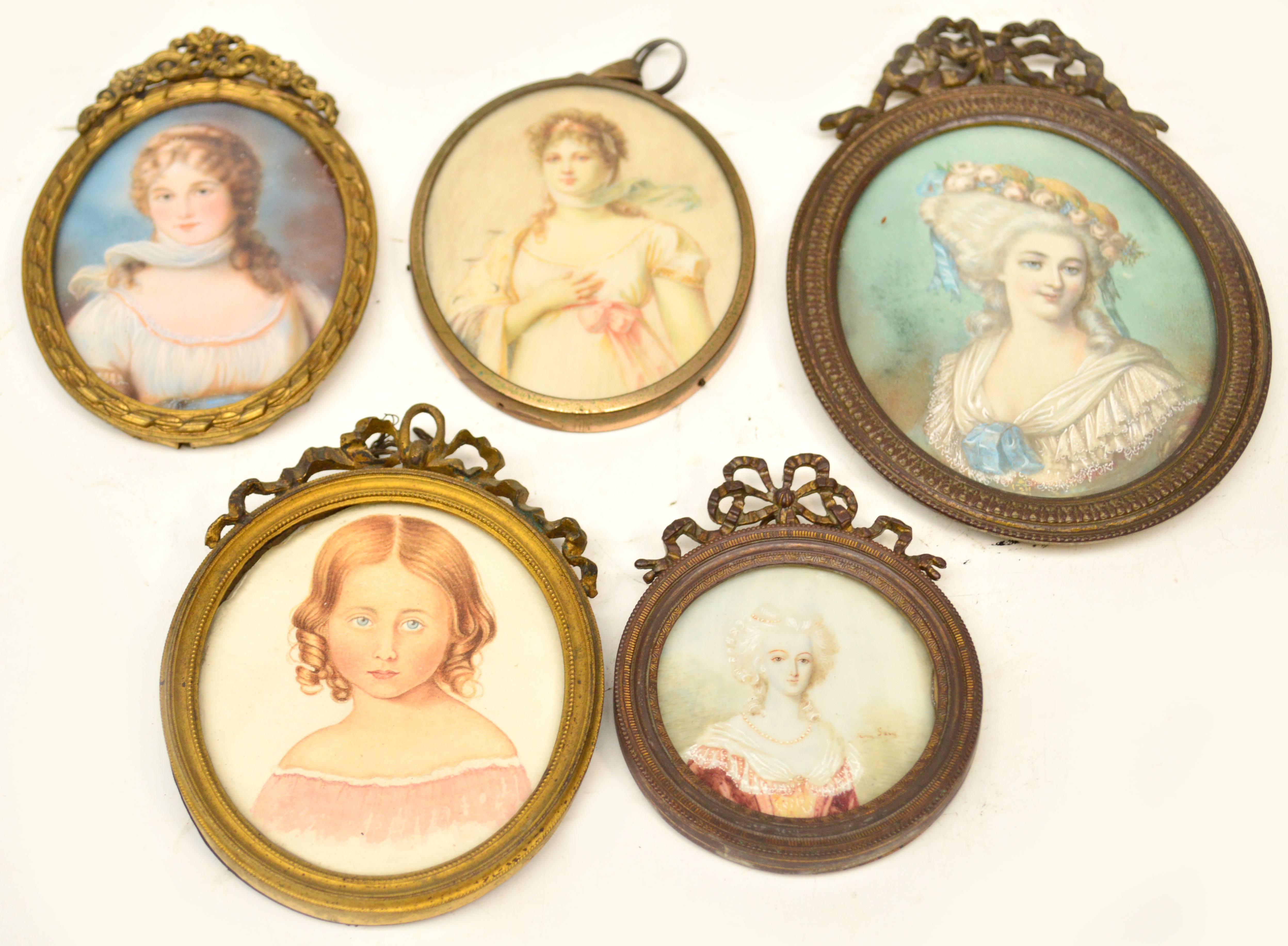 Five oval portrait miniatures depicting young woman wearing various dresses. CONDITION REPORT: