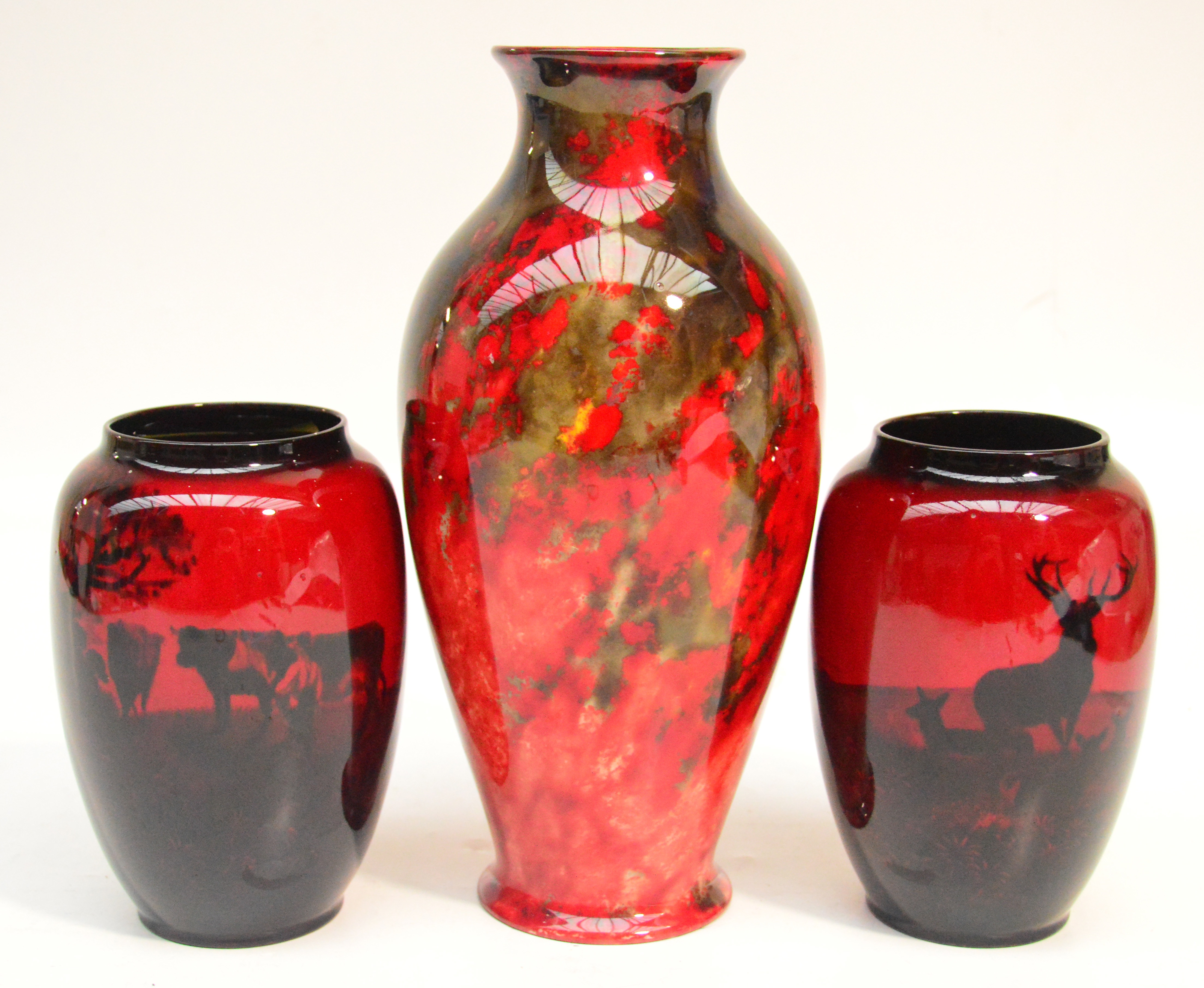 A pair of Royal Doulton flambé landscape decorated vases, height 15.5cm and a larger Royal Doulton