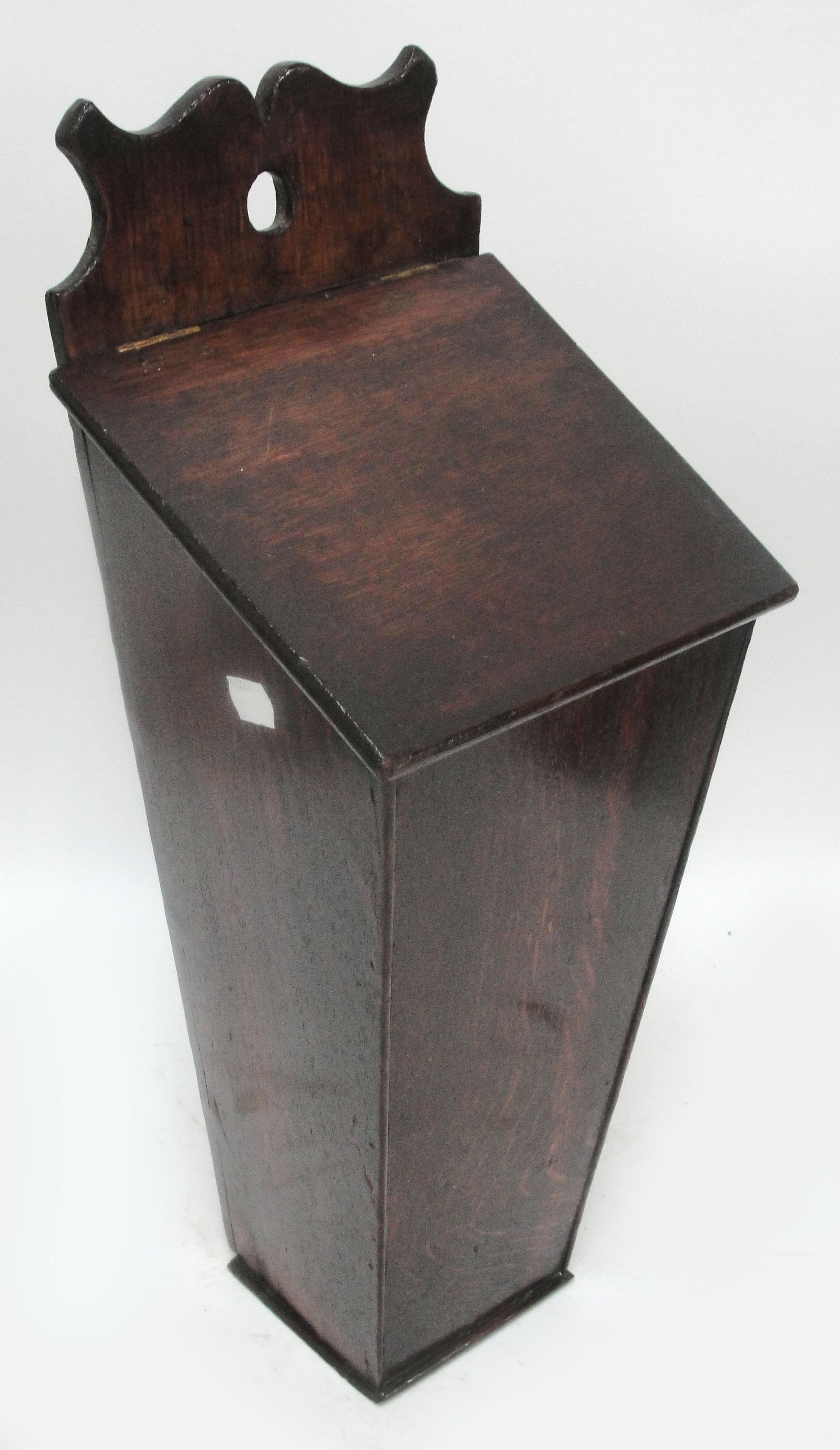A Georgian oak wall mounted salt box with sloping hinged lid, height 53cm.