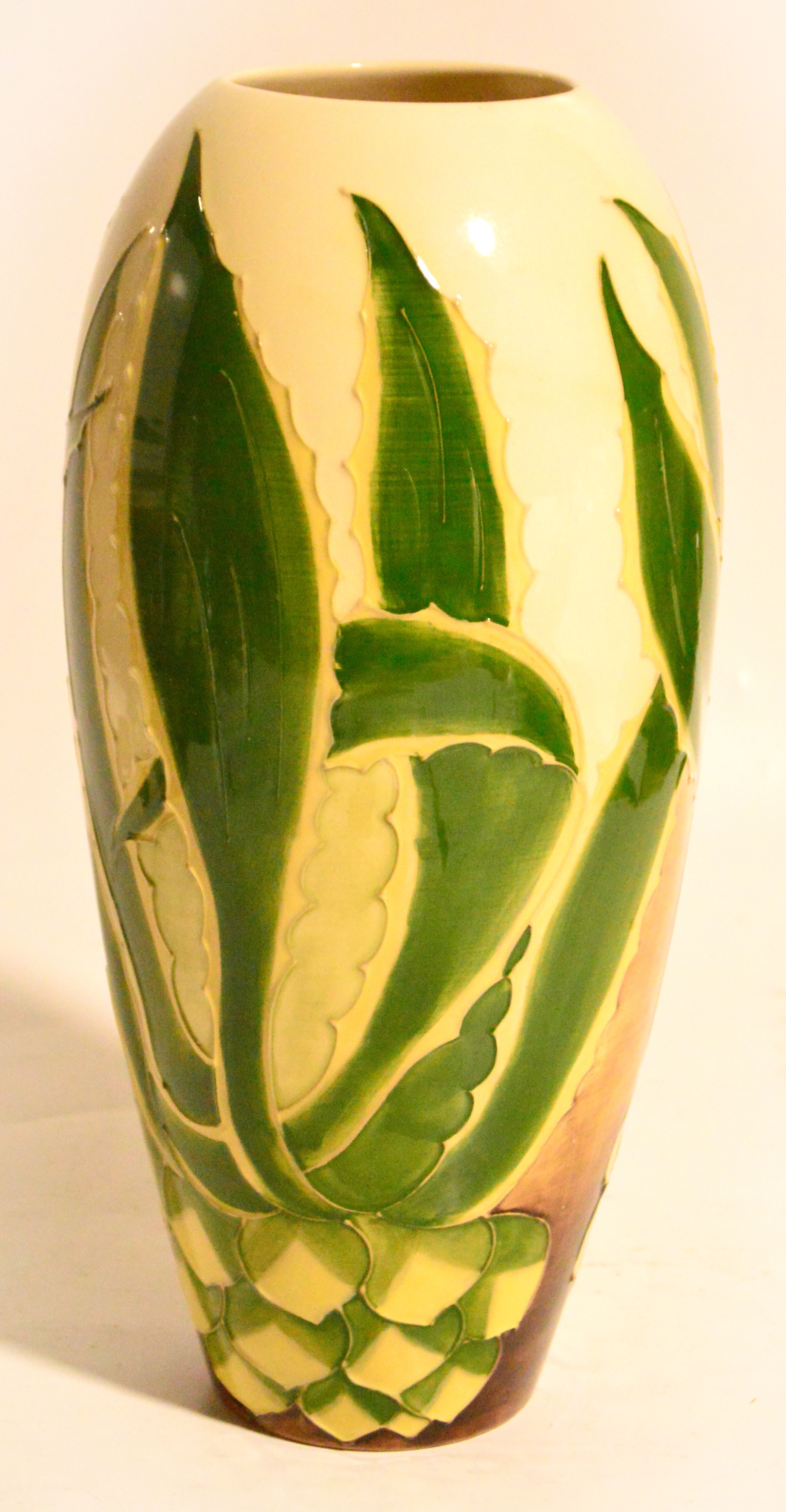 A Moorcroft pottery vase decorated in the "Pineapple" design on a cream ground, signed and dated