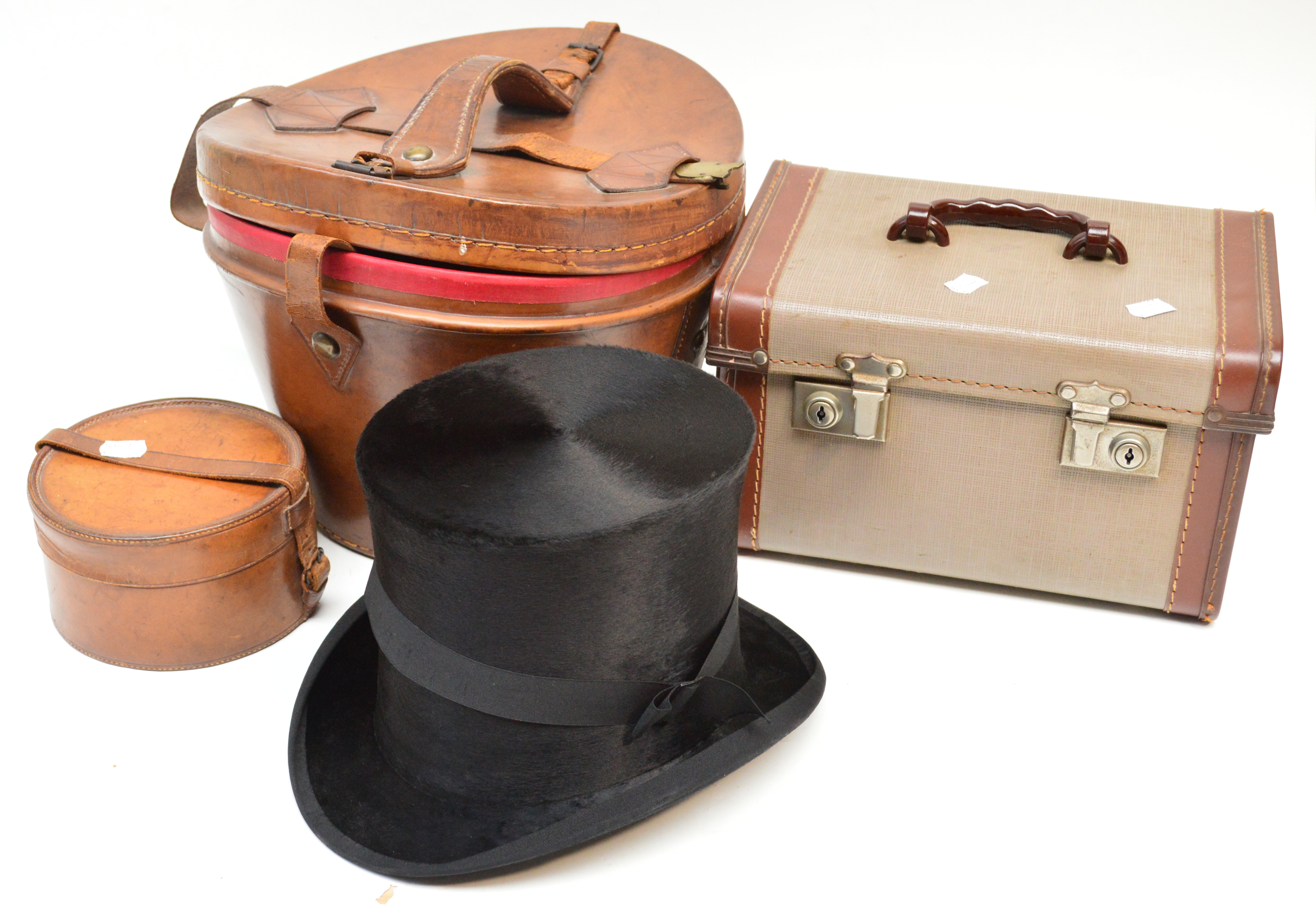 A leather cased silk top hat by Lincoln Bennett and Co, London, a leather hat box and a small