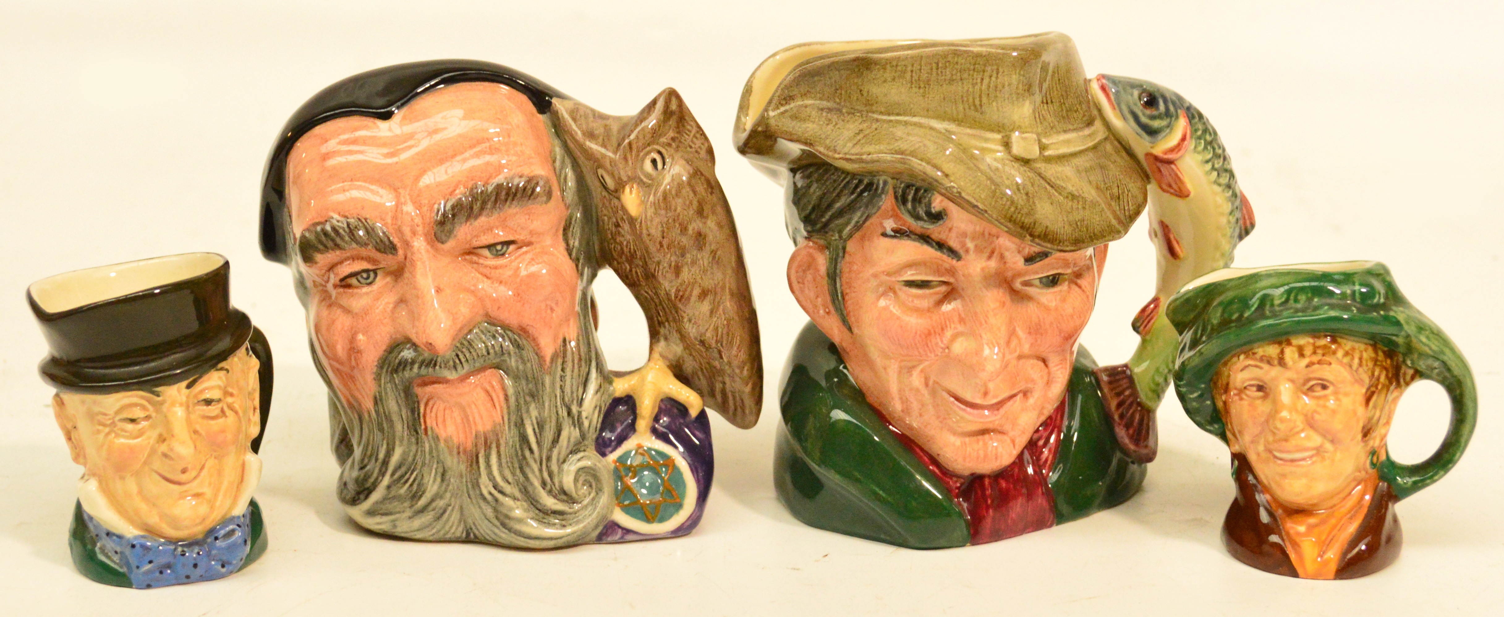 Two small Royal Doulton character jugs and two miniature D6429 "The Poacher", D6536 "Merlin" (