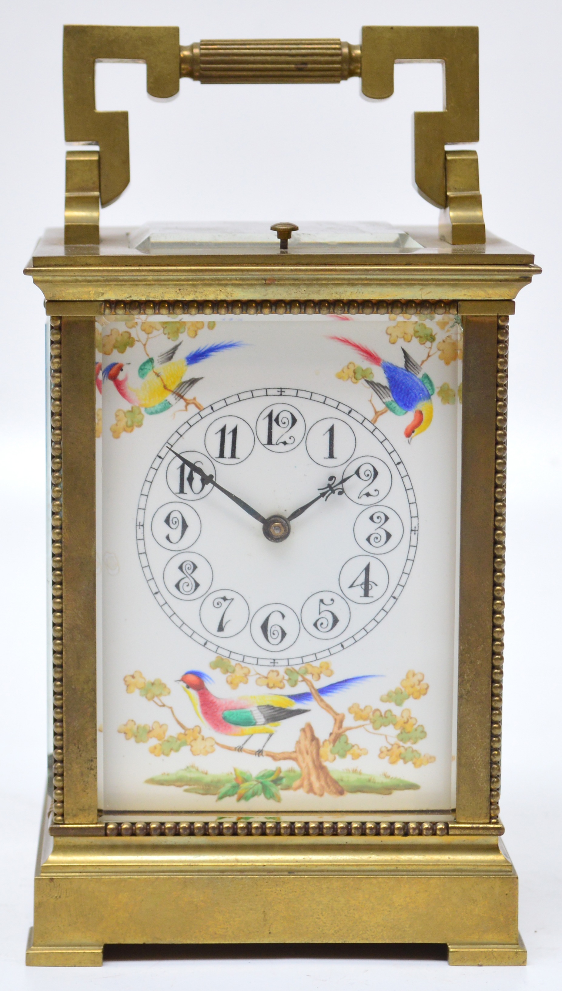 A c.1900 French repeating brass cased carriage clock with angled loop handle above painted