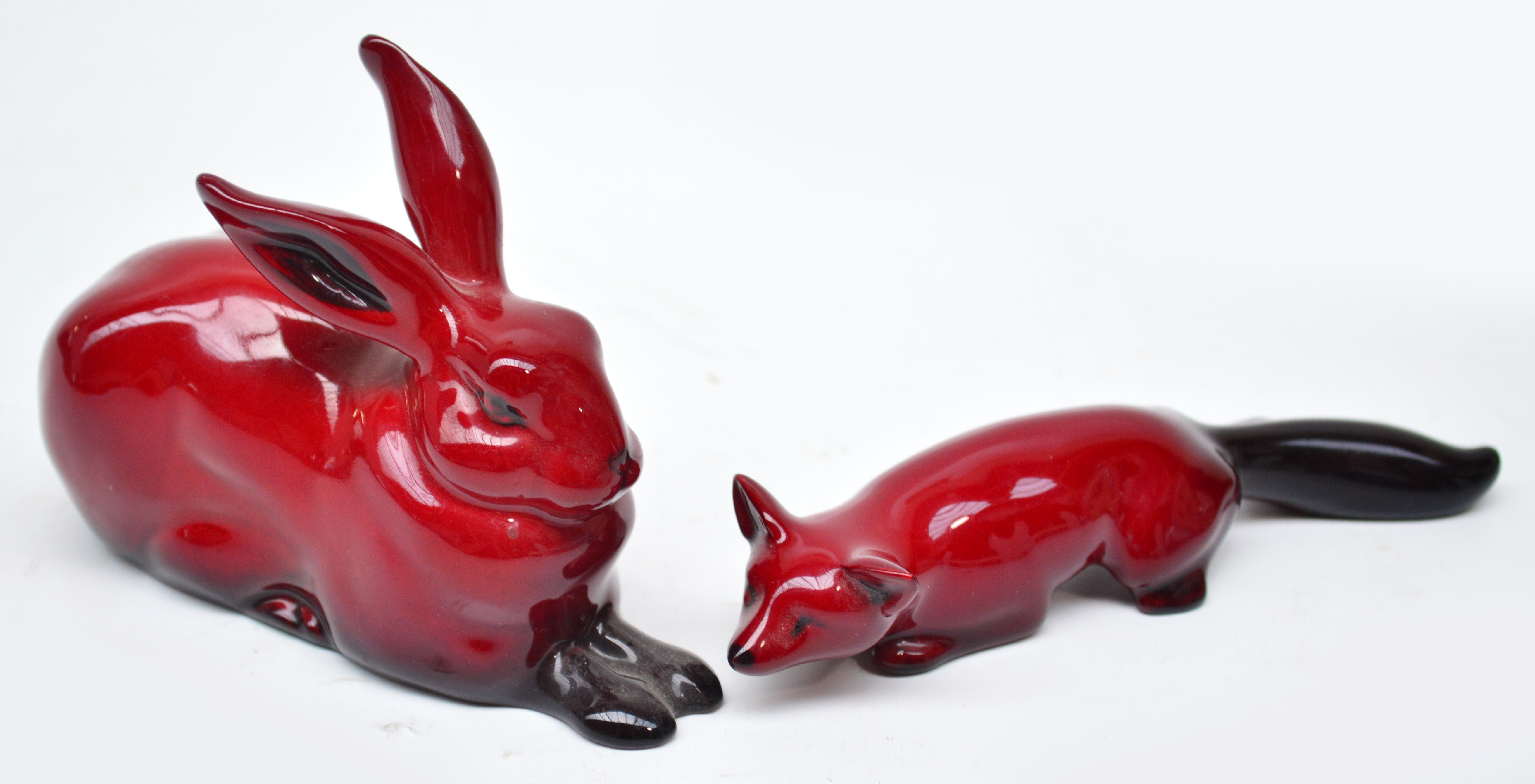 Two Royal Doulton flambé animals comprising hare and fox, lengths 11.5cm and 14cm. CONDITION REPORT: