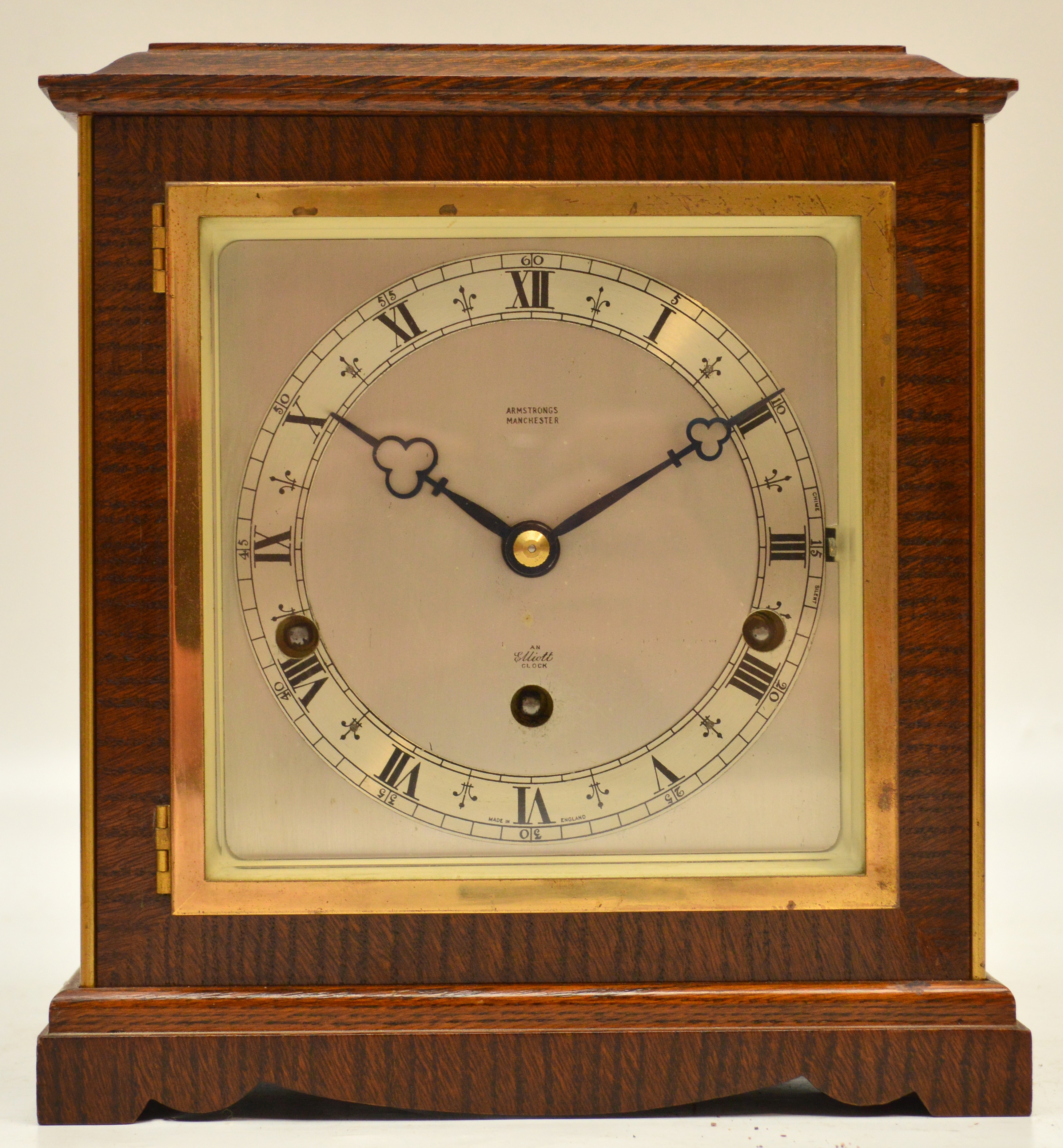 A 1940's oak cased mantel clock, the silvered square dial set with Roman numerals and with chime/