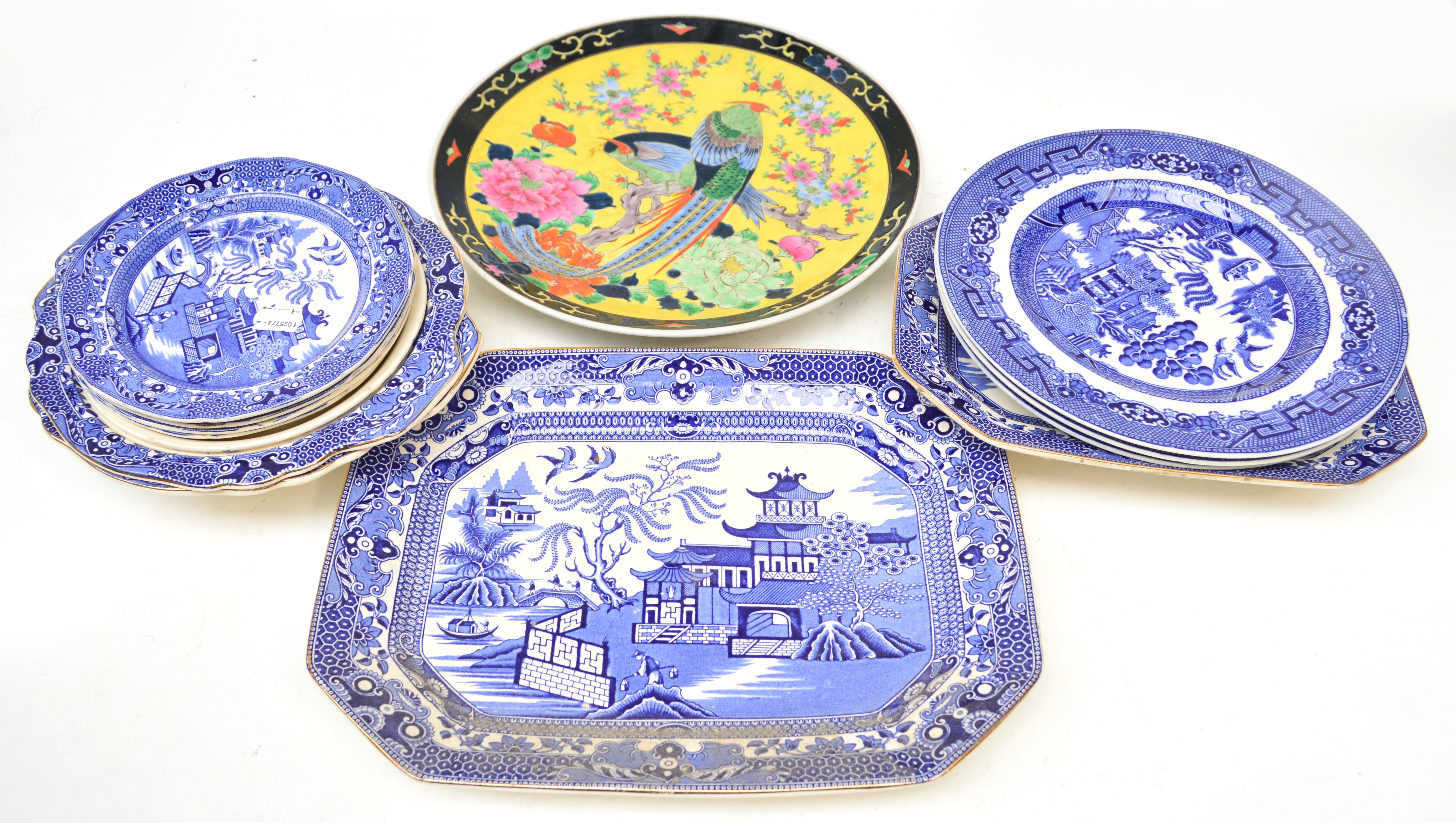 A quantity of blue and white willow pattern dinner and tea ware and a Japanese charger decorated