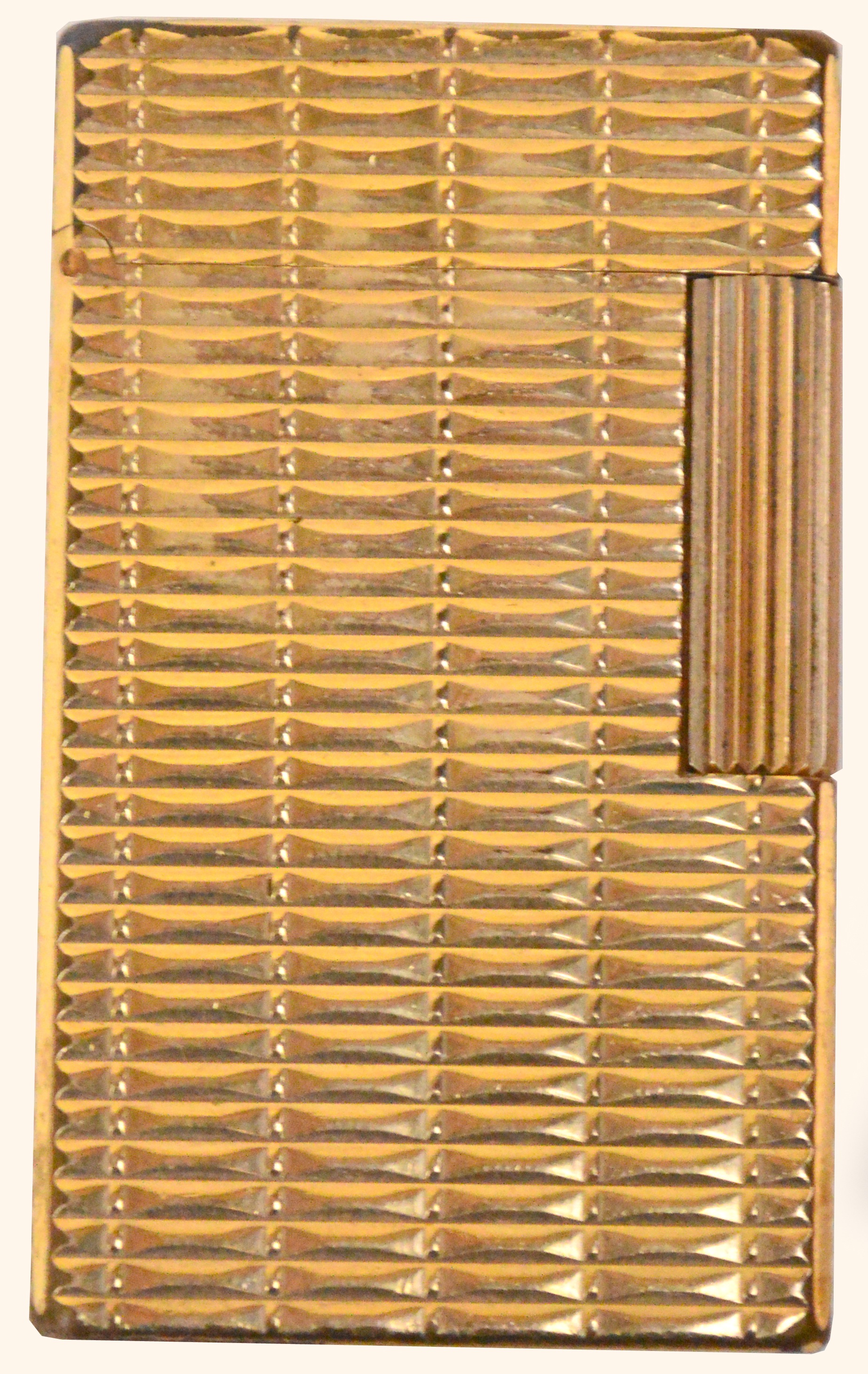 A gold plated Dupont lighter with rectangular textured case.