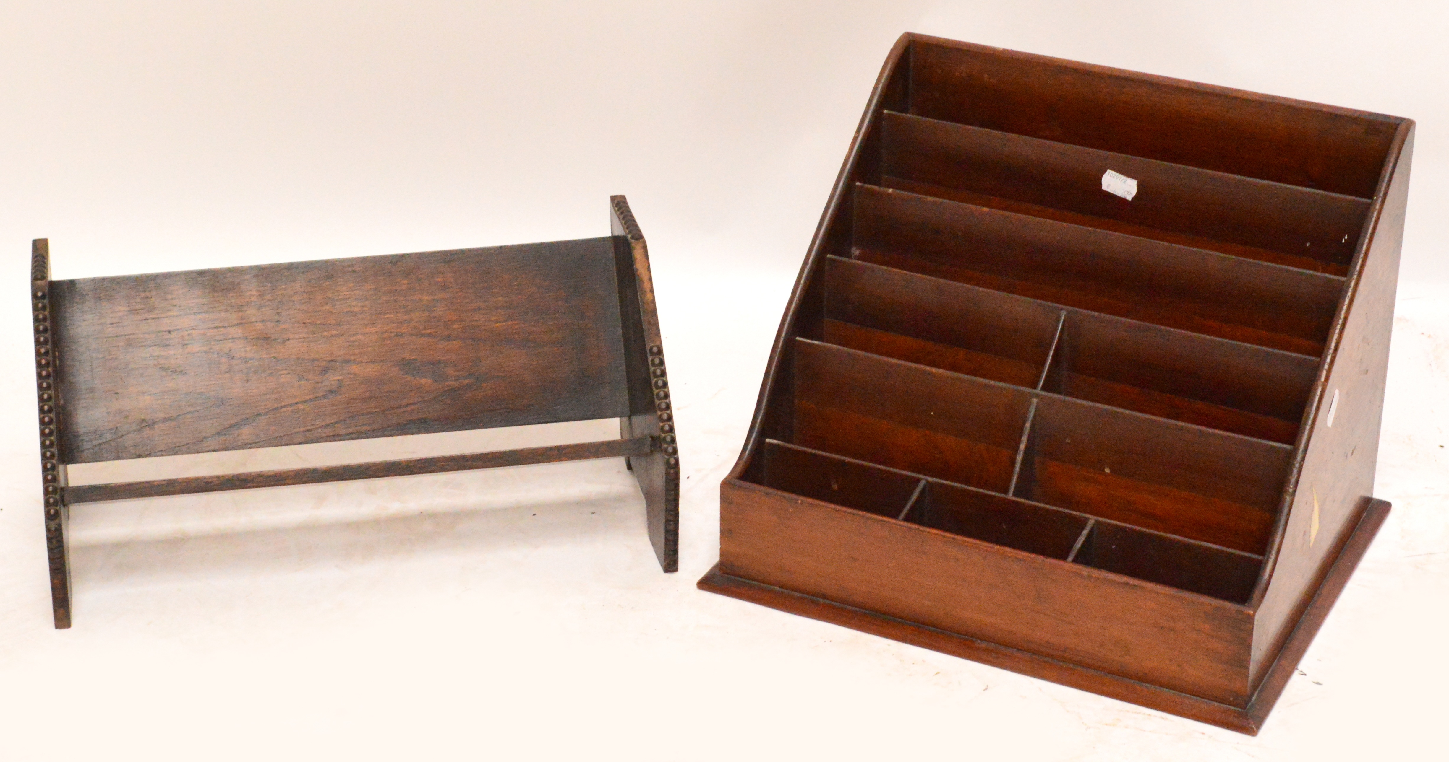 An early 20th century mahogany six section letter rack, width 38cm and an oak bookrack, width 42cm.