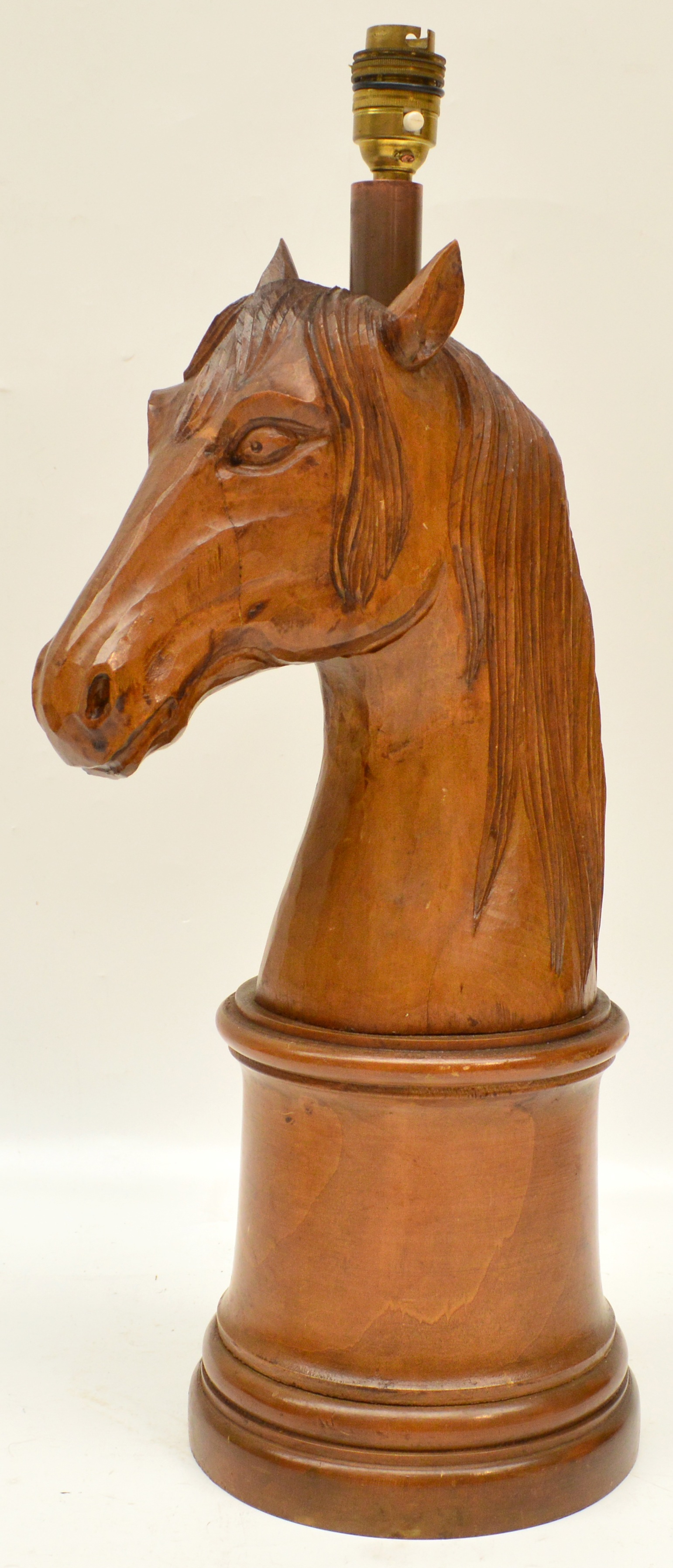 A carved wooden lamp base modelled as a horse's head, height 45cm.