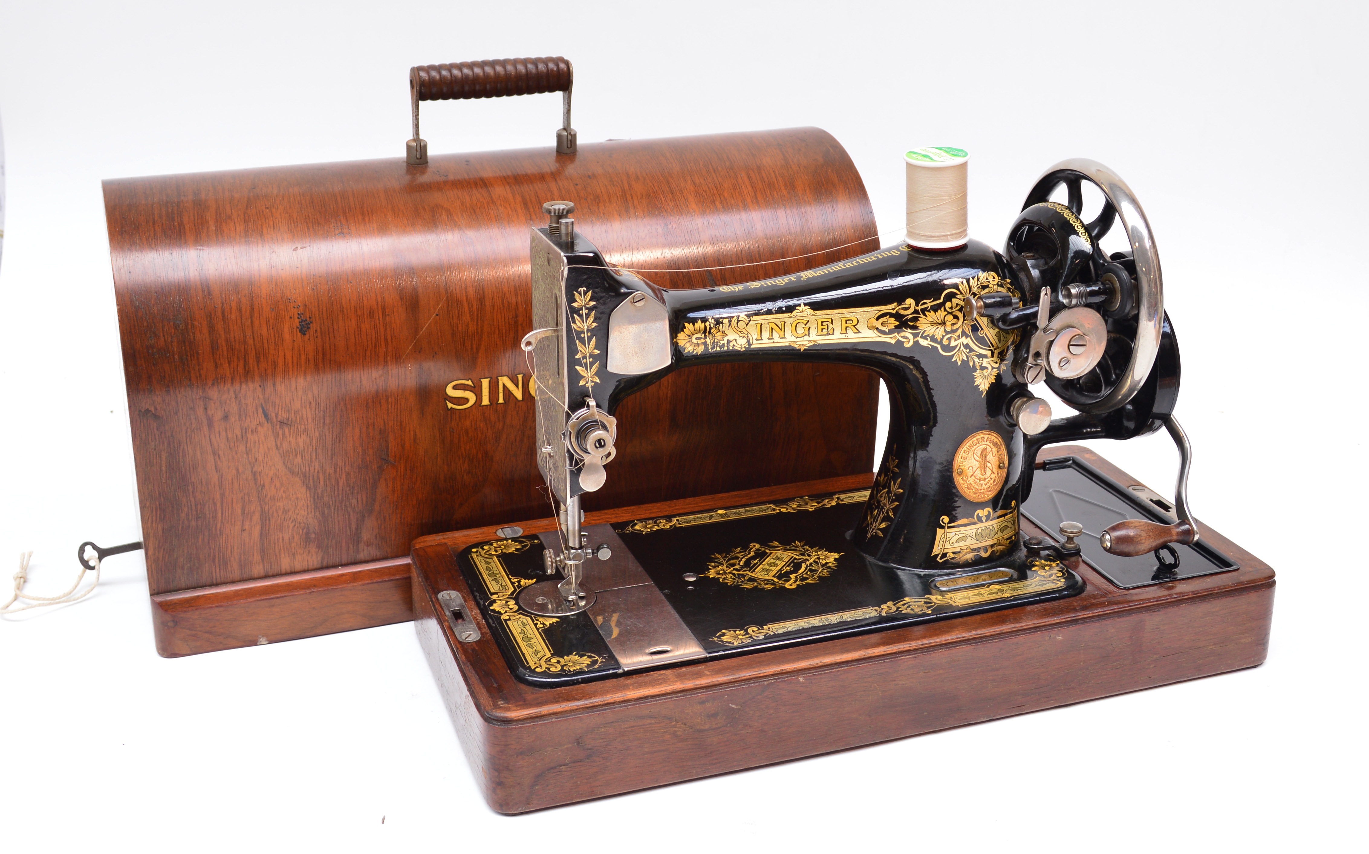 A vintage Singer sewing machine in walnut veneered domed case.