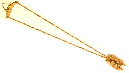 A 9ct gold pendant in the form of a twin hinged front Torah scroll revealing an image of the Tablets