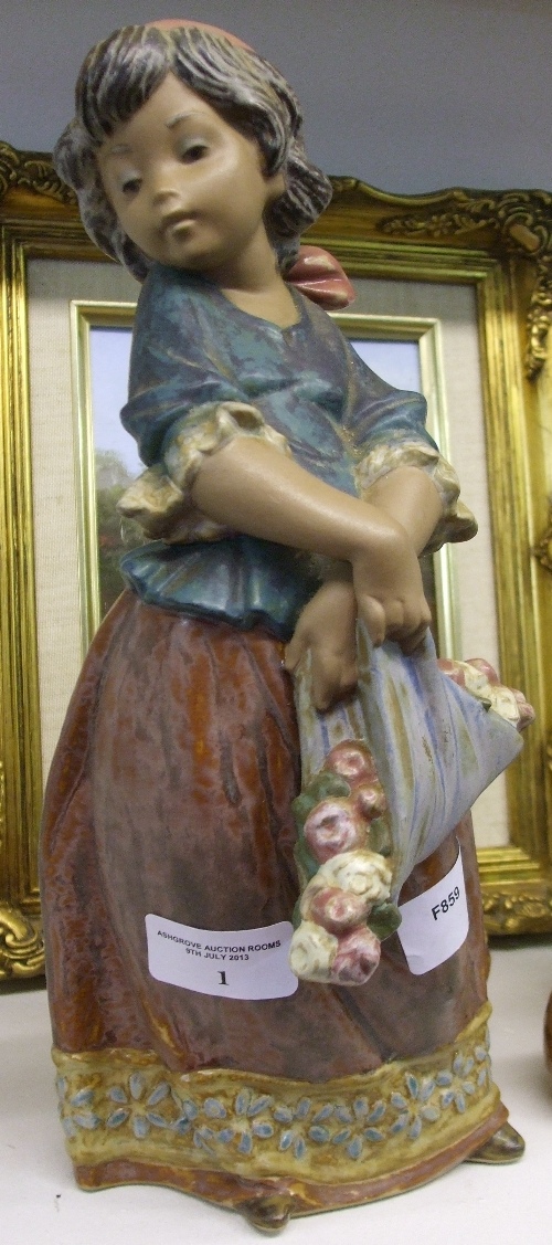 A Lladro Figure of a Young Girl Carrying Bundle of Flowers, 30cm high.