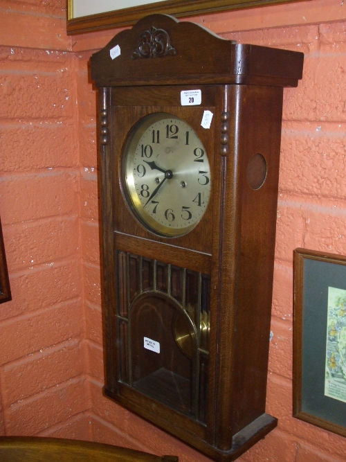 An Oak Wall Clock with Bim-Bam Double Chime with an interesting brass detailing and brass