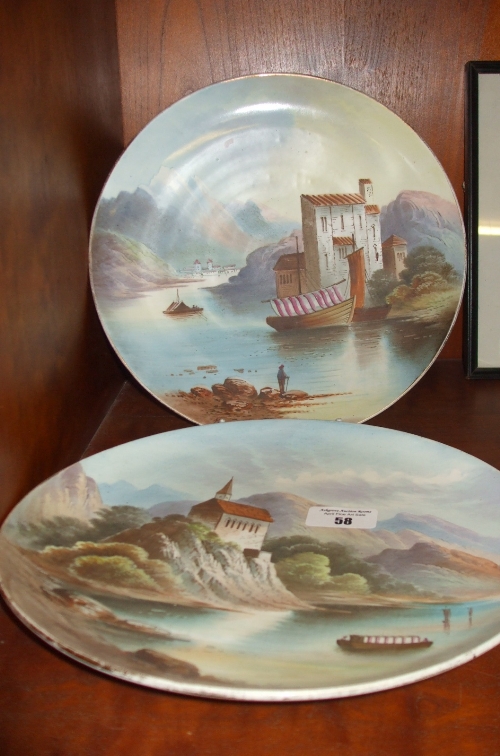 A Pair of Hand Painted Cabinet Plates, titled `Lake Maggiore` and `Tell Chapel`, initialled `H.H.`