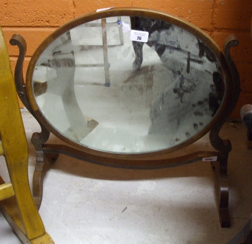 A Mahogany and Inlaid Oval Dressing Table Mirror.