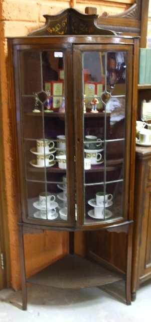 An Edwardian Inlaid Corner Cabinet.