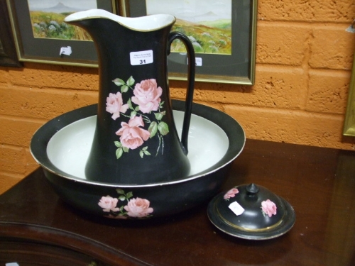 A Black Ceramic Wash Jug, Bowl, and Soap Dish, with pink rose decoration.