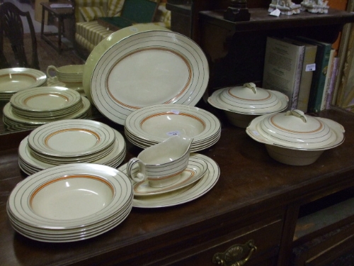 A Quantity of Woods Ivory Ware Dinner Wares comprising two lidded tureens, two platters, sauce