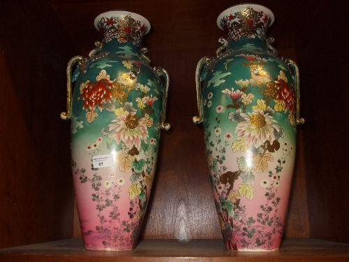 A Substantial Pair of Japanese Vases decorated with birds amongst foliage with gilded highlights and