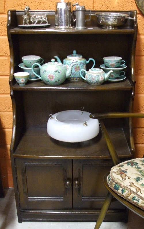 An Ercol Bookcase, with two shelves above twin panel doors.