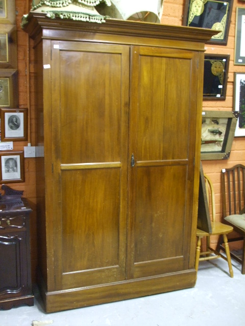 A Mahogany Double Wardrobe with a pair of panelled doors, height 210cm, width 141cms.